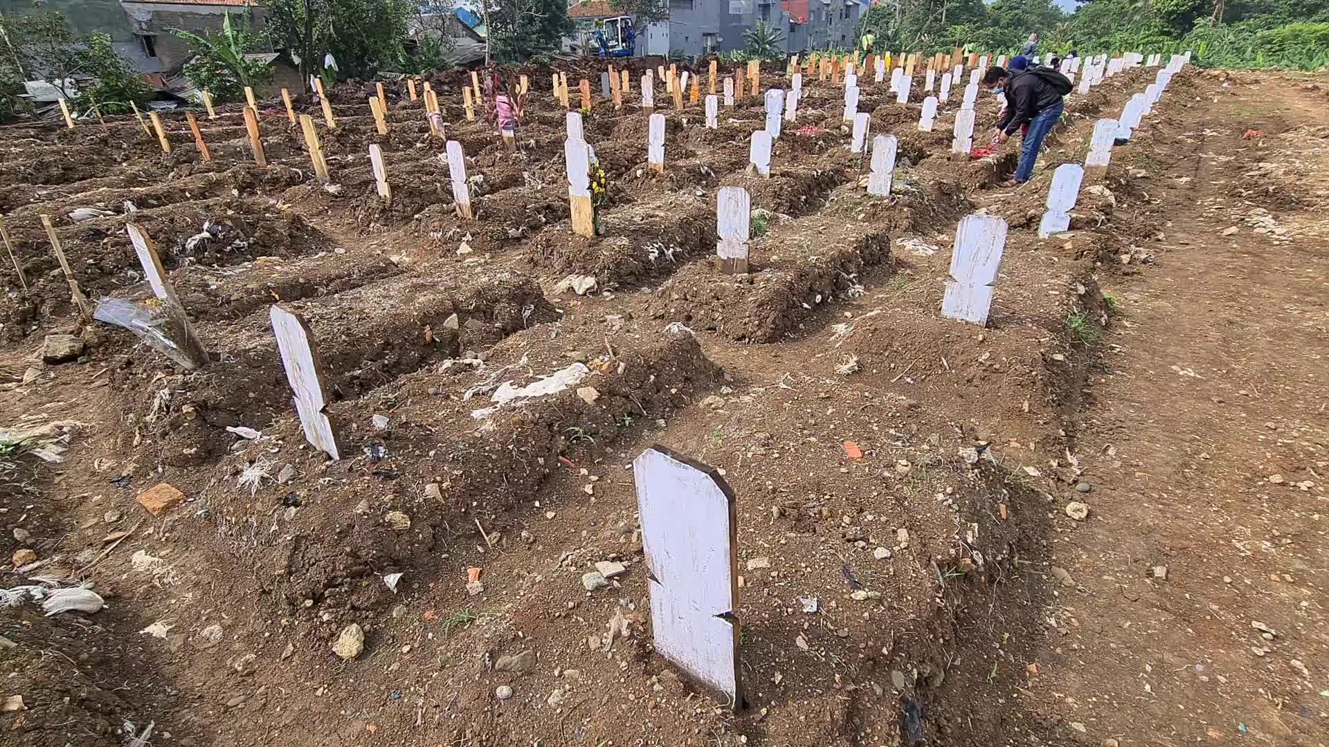 People visits a Covid-19 graveyard in Indonesia