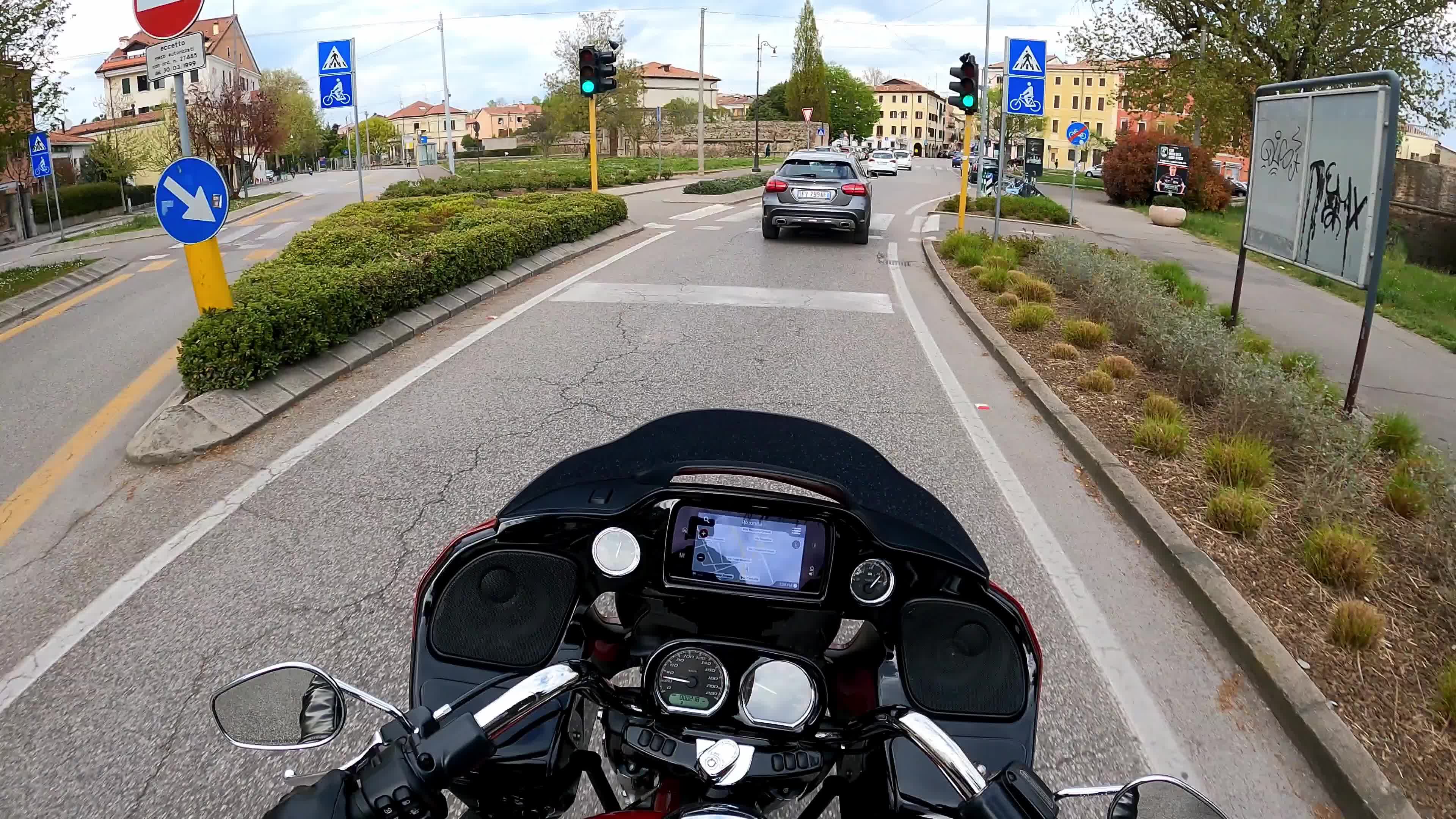 Timewarp of a man driving a Harley Davidson for the roads of Padova