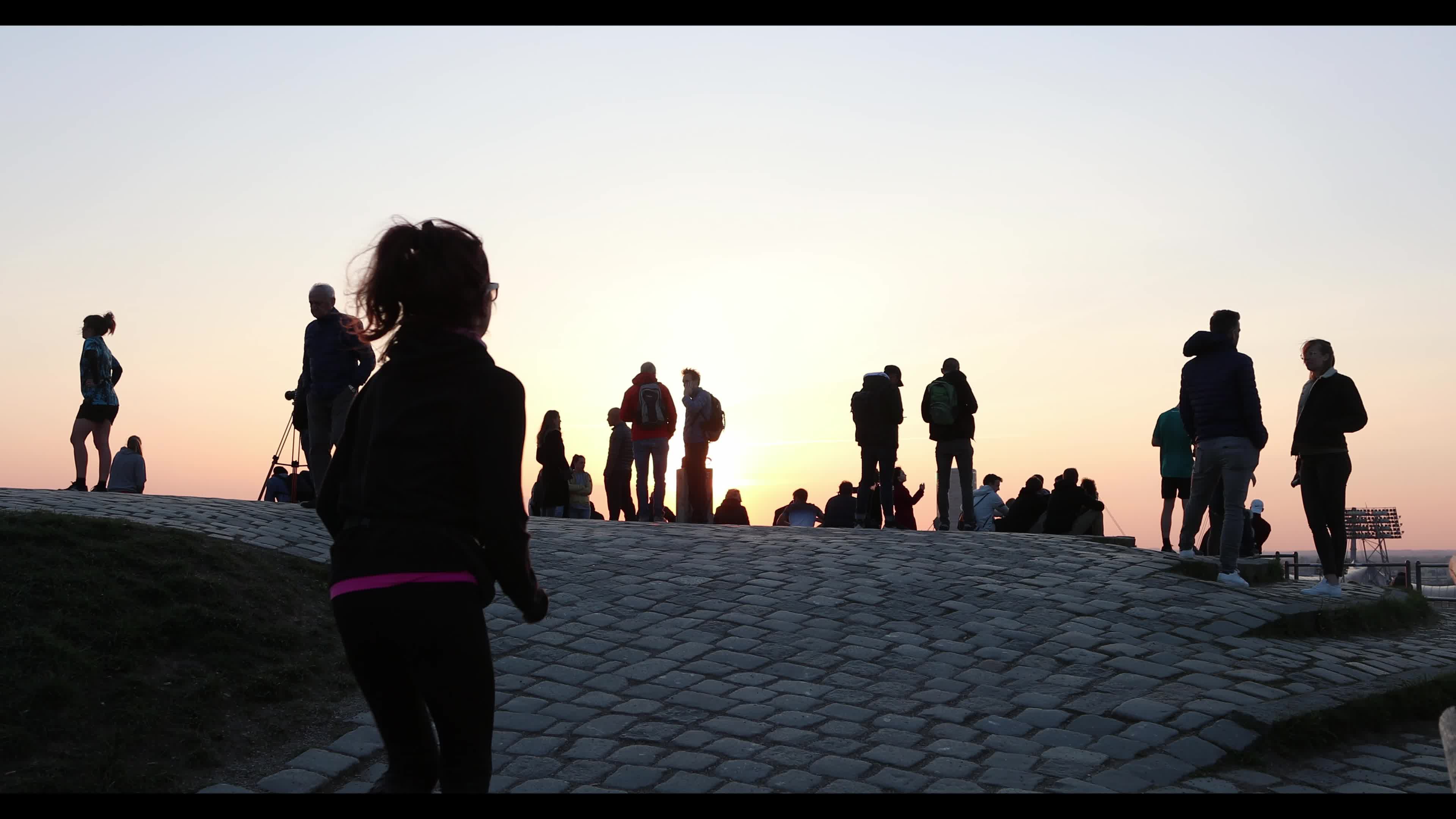 People enjoy the sunset in the Olympic park in Munich