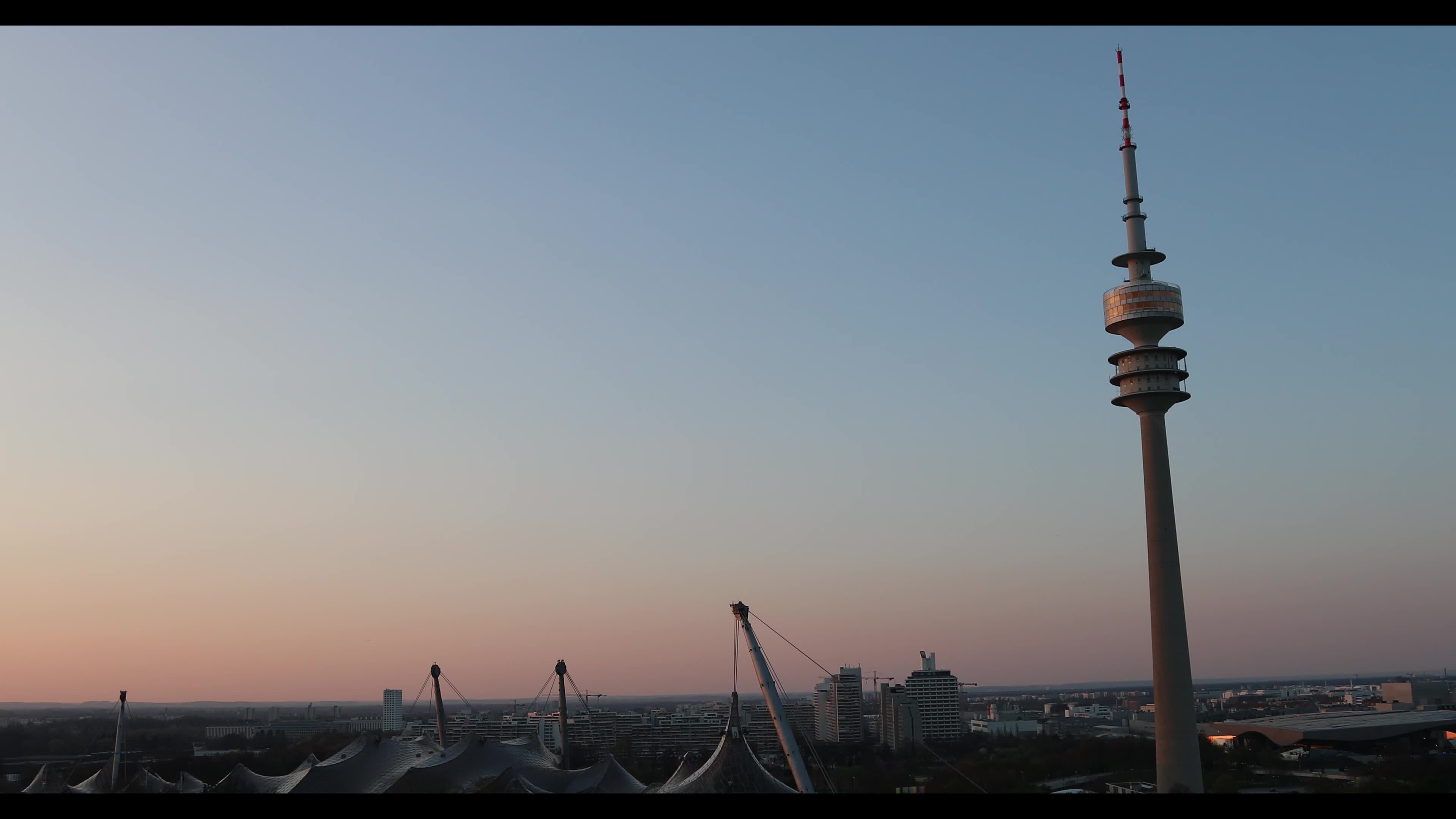 People enjoy the sunset in the Olympic park in Munich