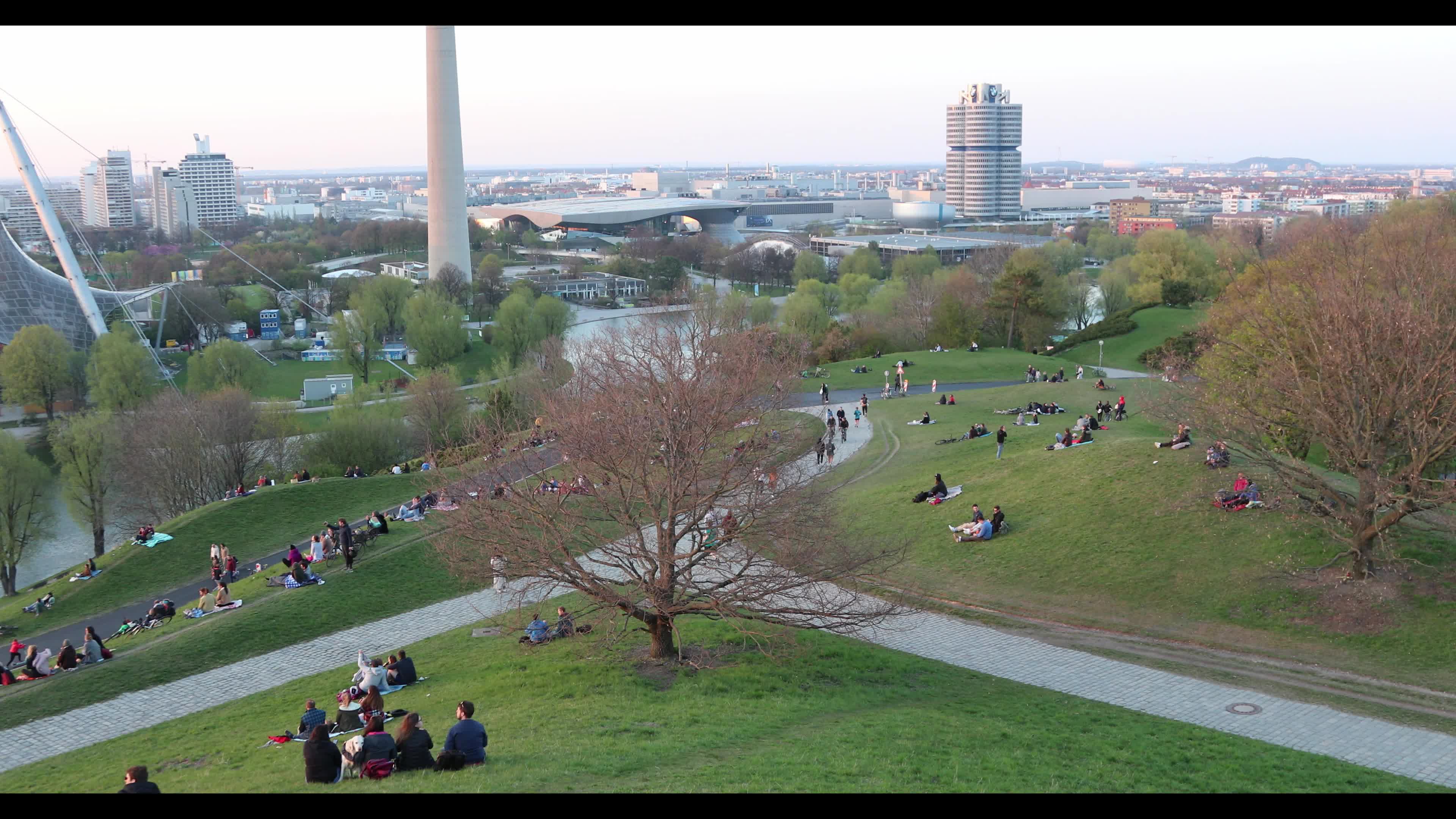 People enjoy the sunset in the Olympic park in Munich