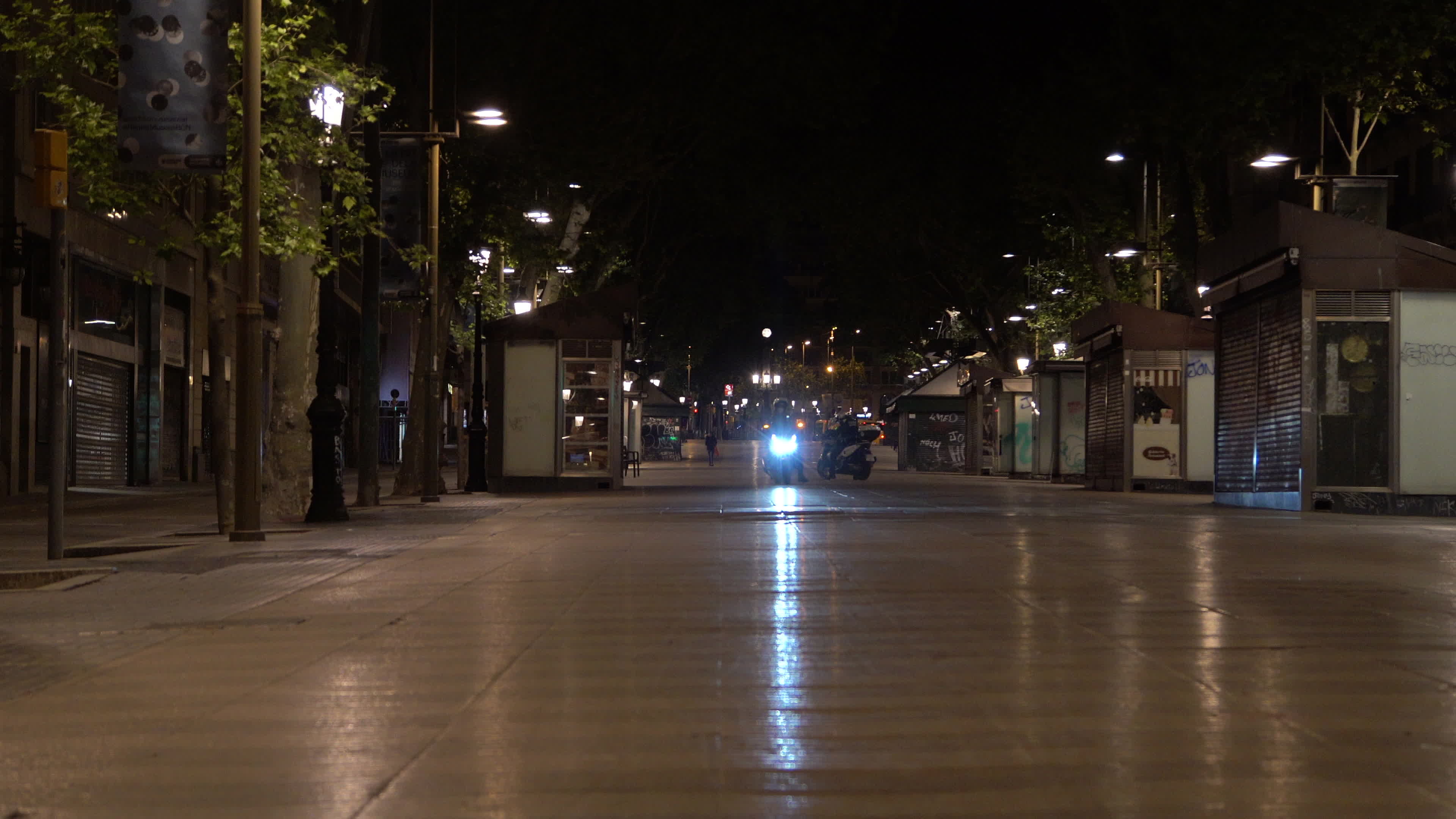 Police officers passing by Las Ramblas during his patrol while curfew is on