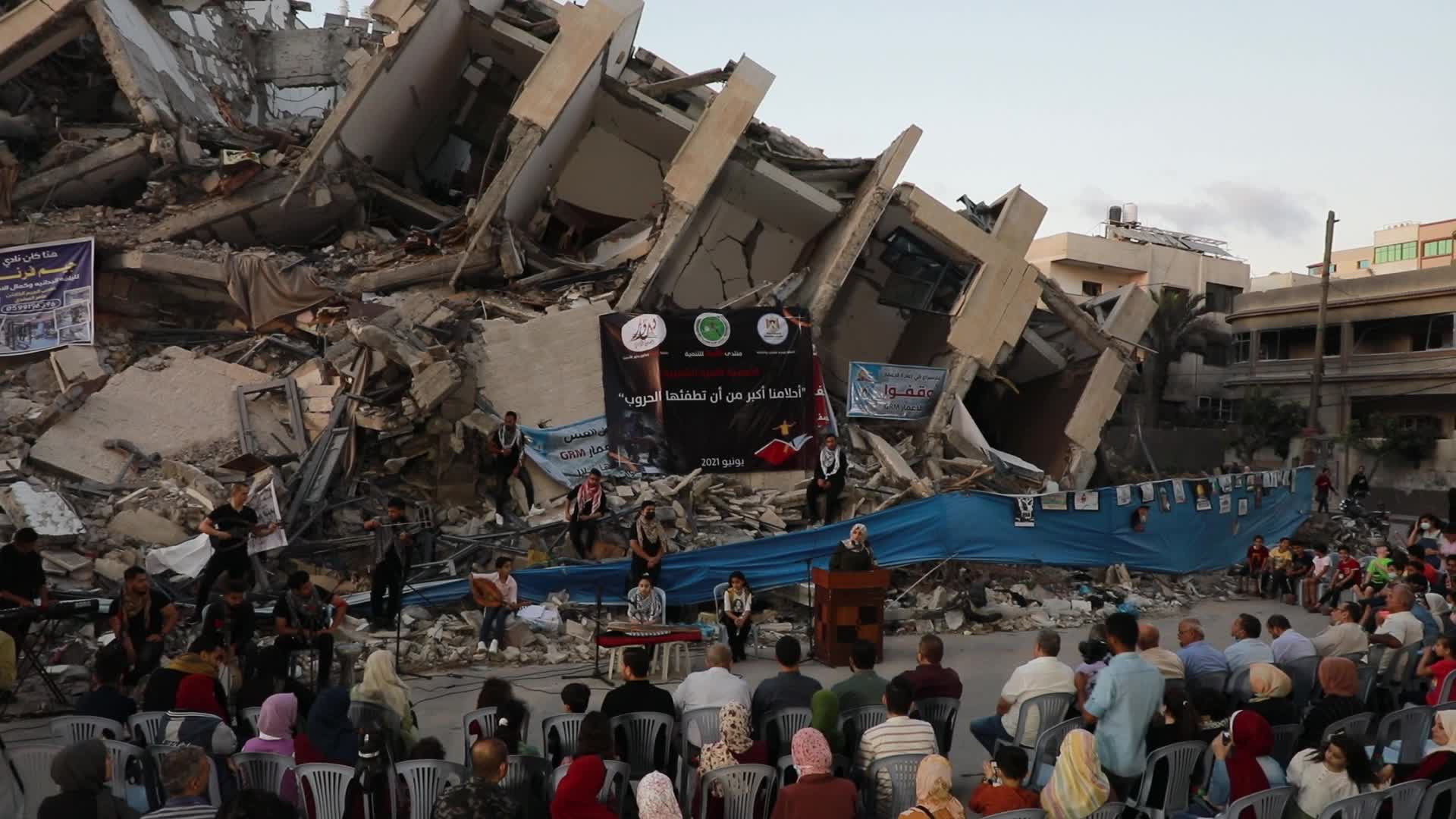 Singers perform on rubbles of a building in Gaza