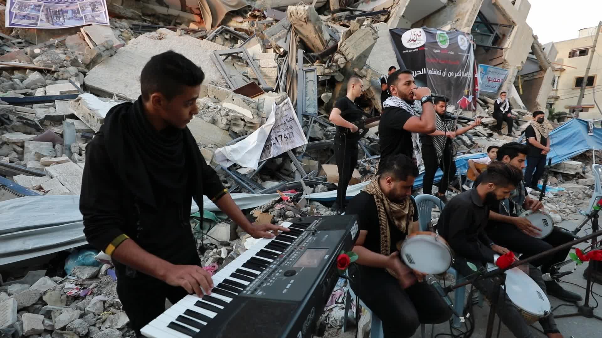 Singers perform on rubbles of a building in Gaza