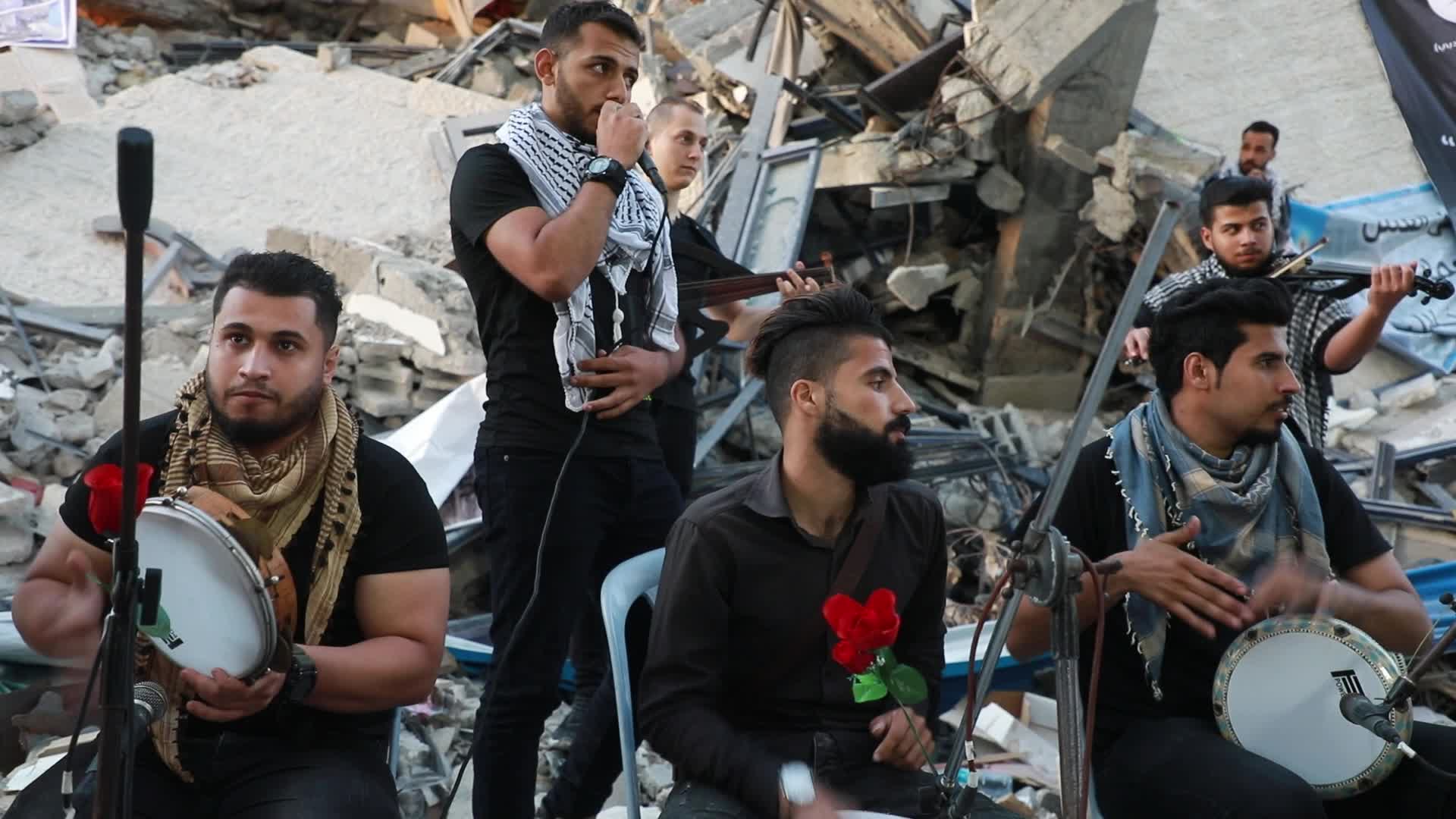 Singers perform on rubbles of a building in Gaza