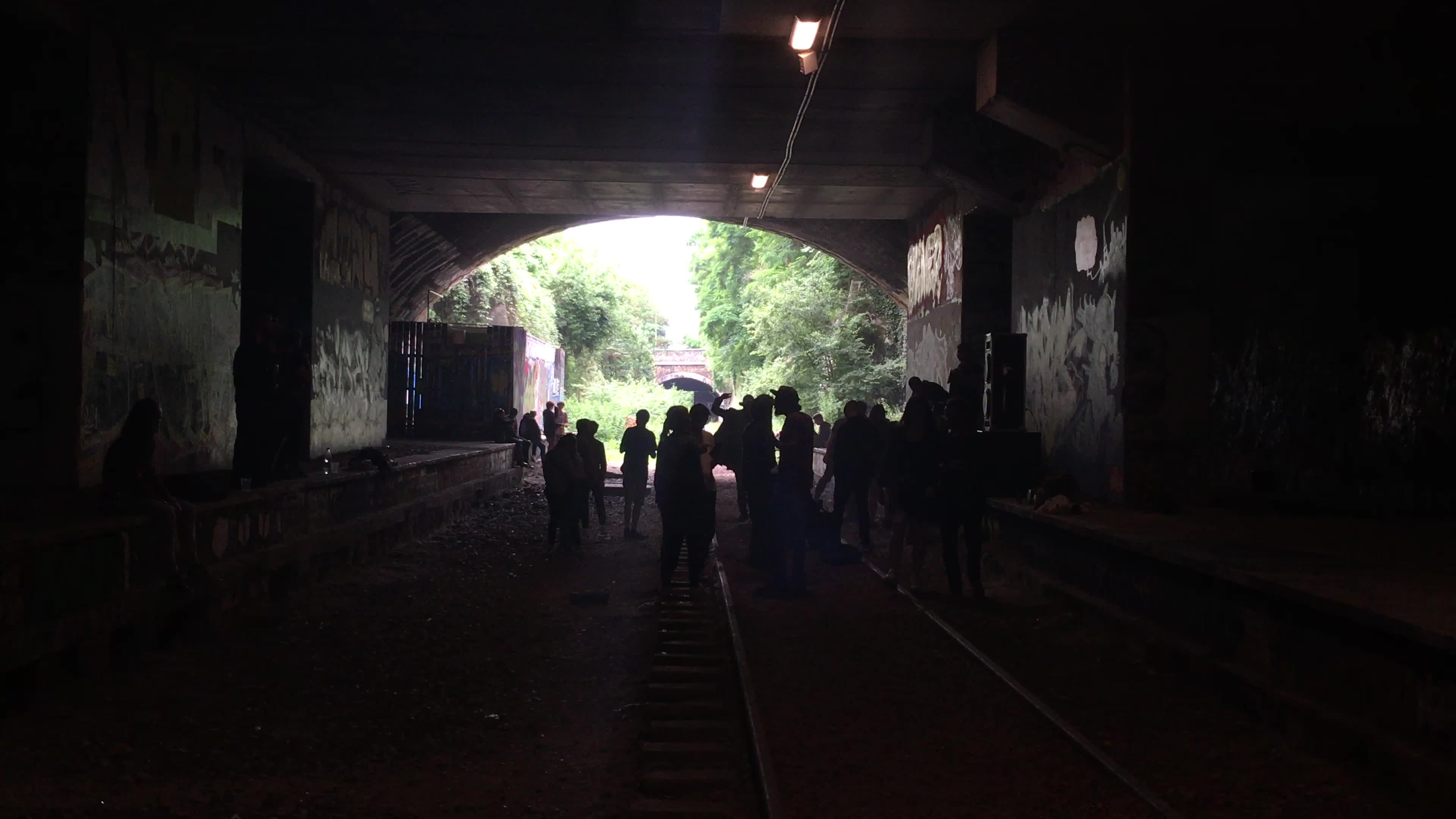 Young people partying in a tunnel old rails in Paris