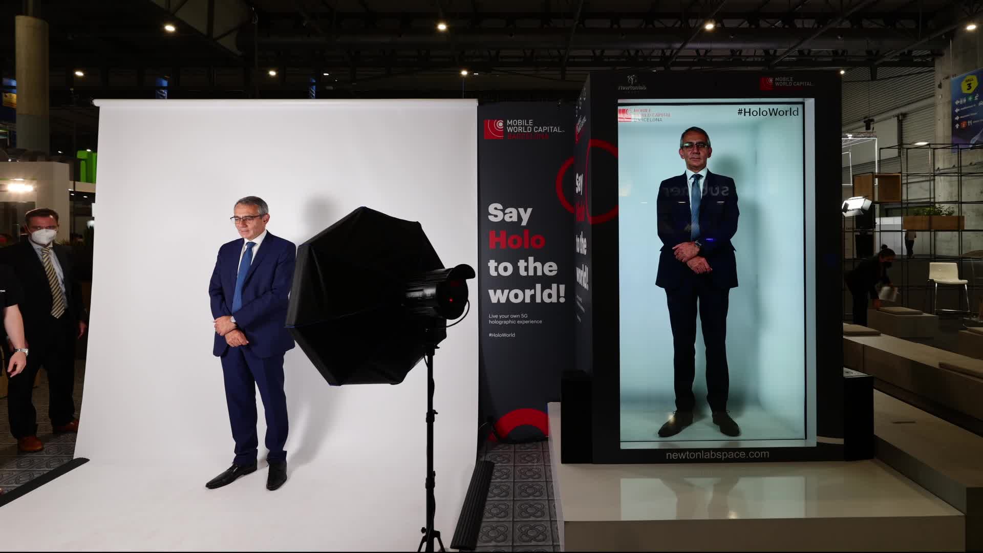 A congress attendant possing with his hologram