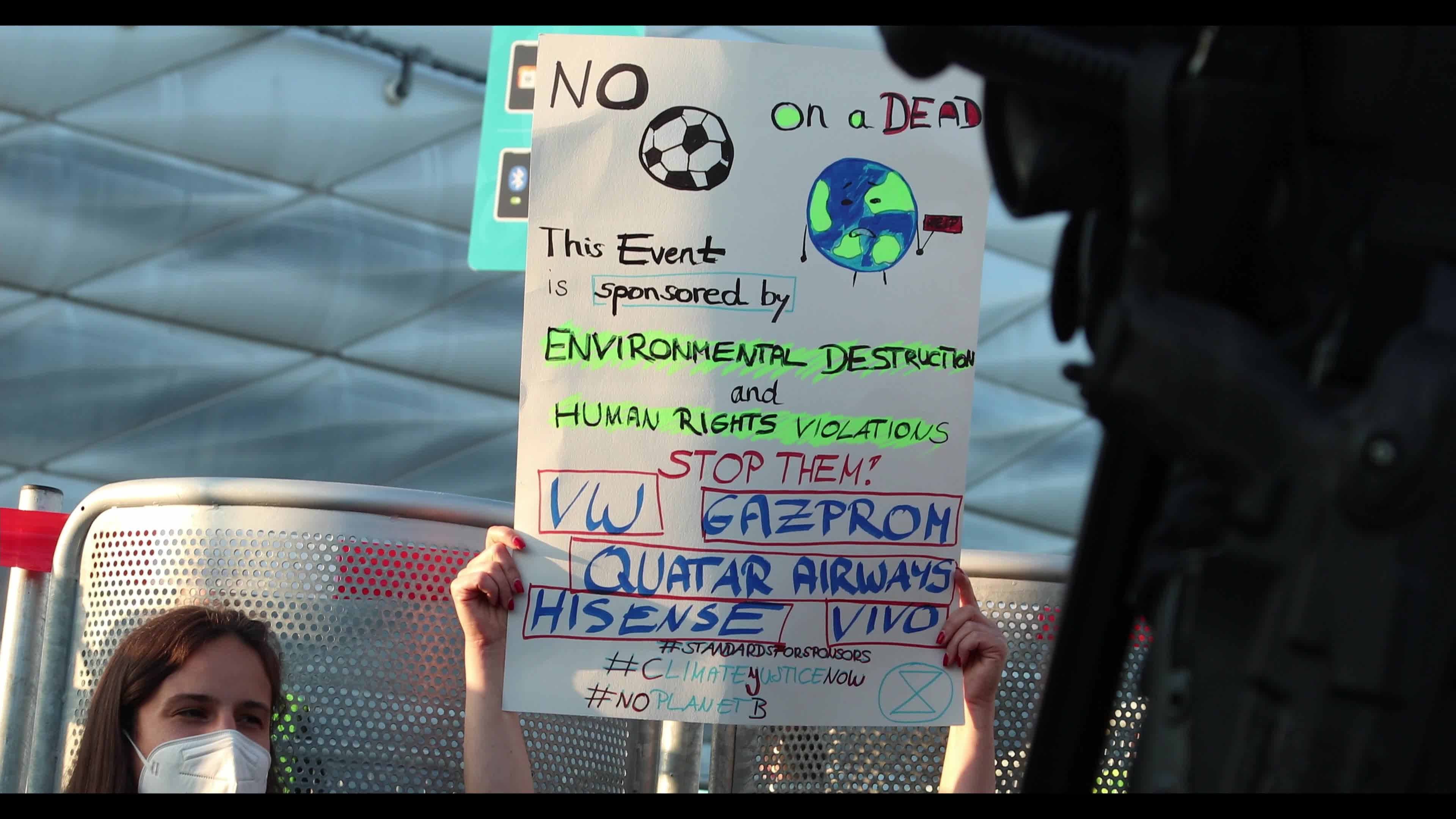Extinction Rebellion activists protest in front of the Allianz Arena