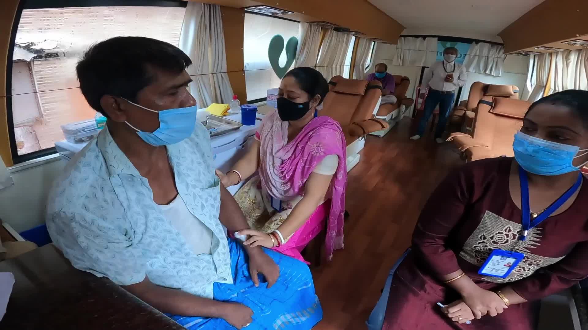 Shopkeeper takes vaccination organised by Kolkata Municipal Corporation