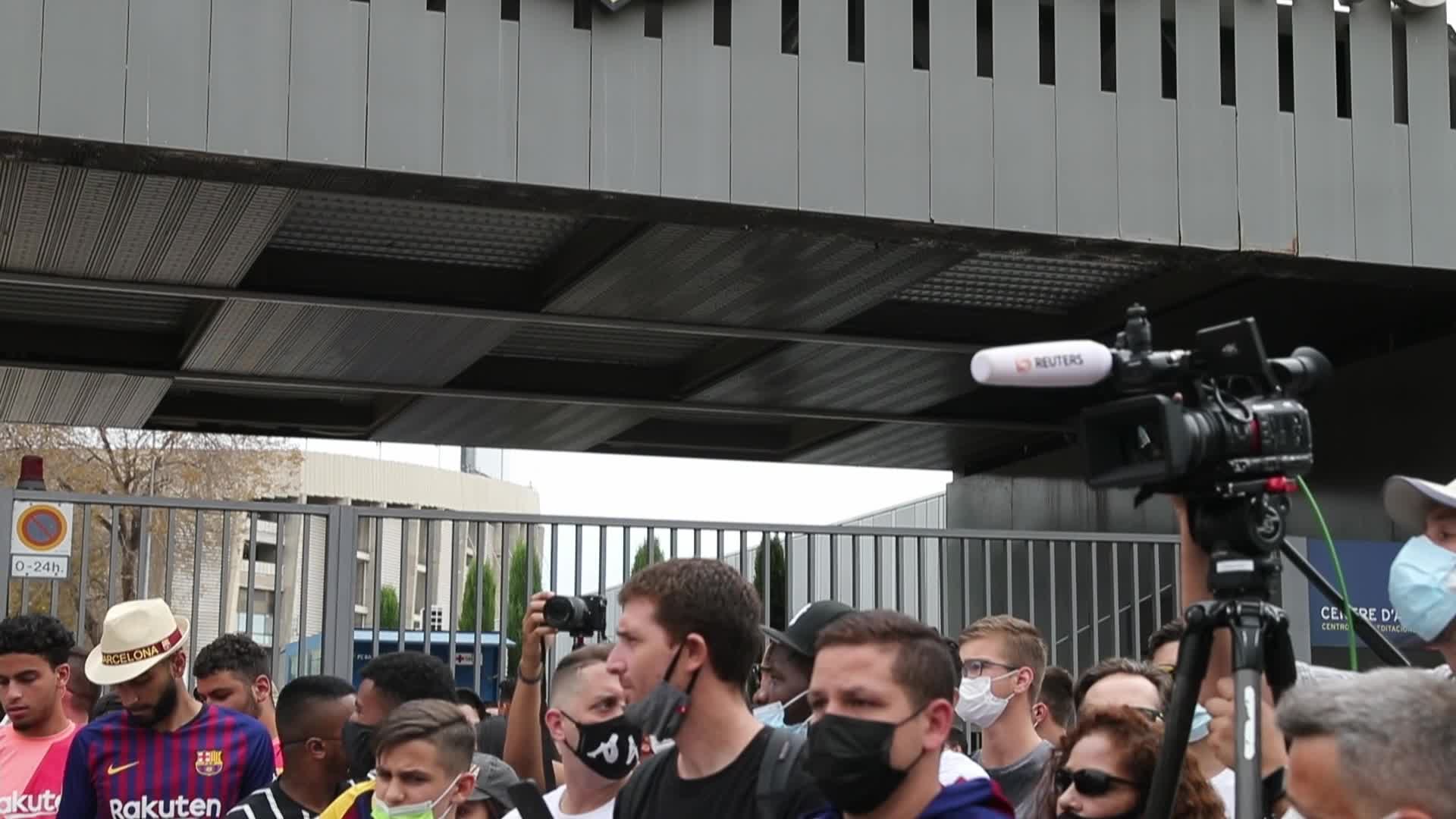 Supporters of FC Barcelona outside the stadium during the press conference of Lionel Messi