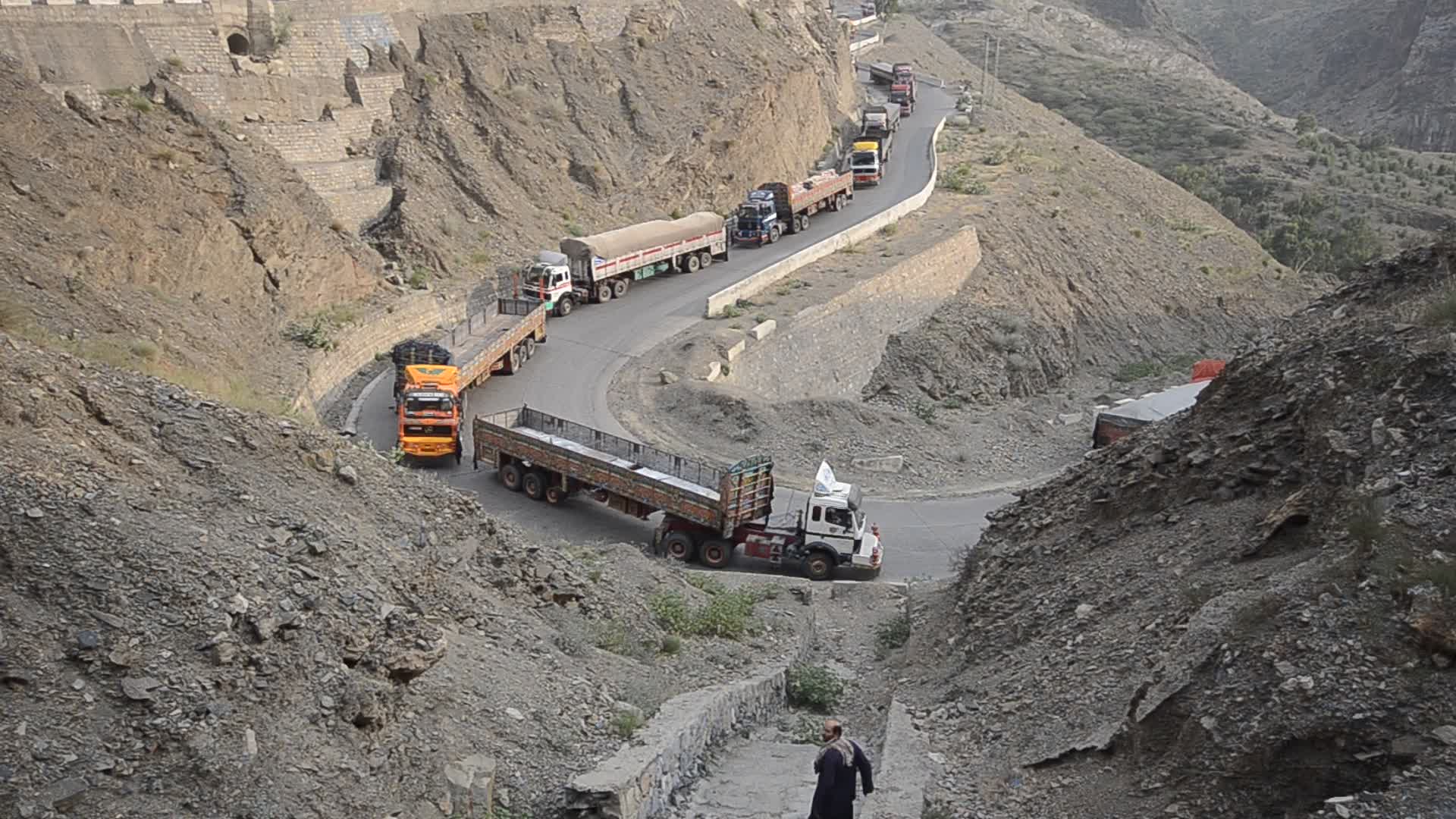 Taliban fighters and Pakistani soldiers guard the Torkham crossing side-by-side in Peshawar