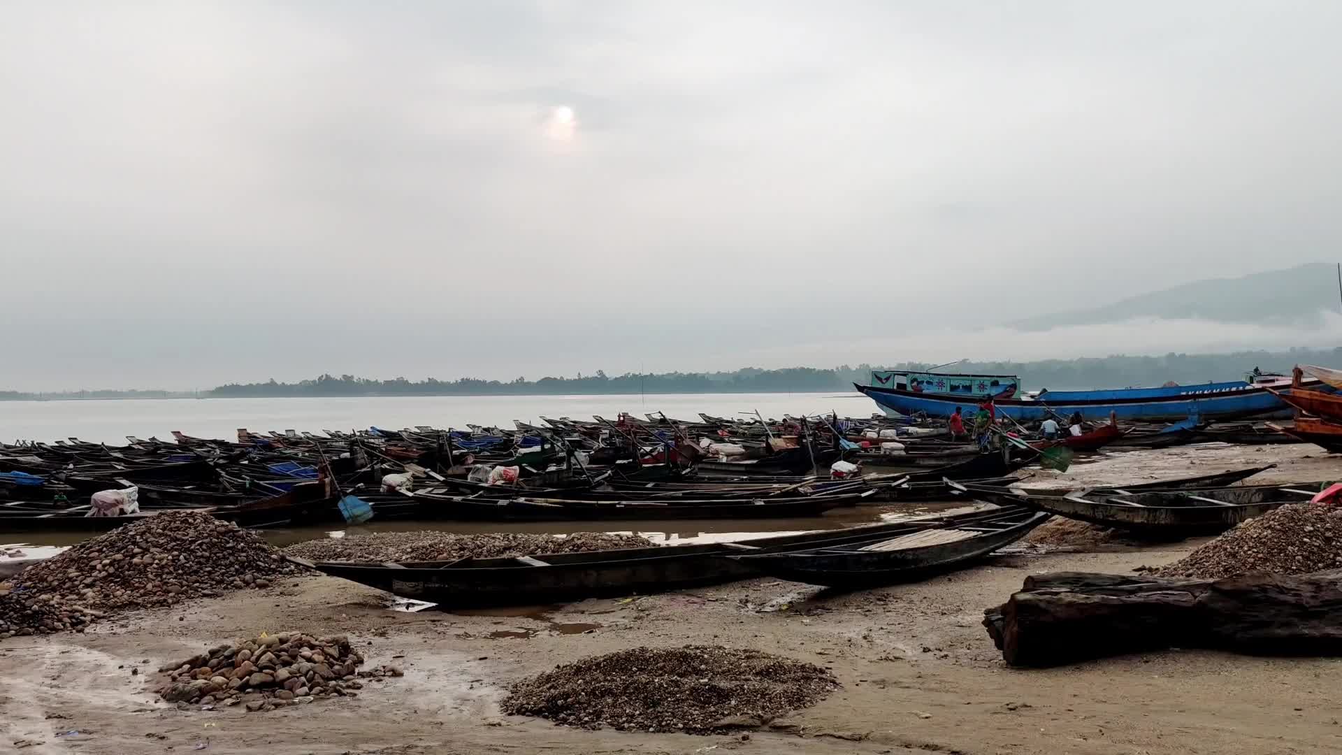Workers carry and collect stones