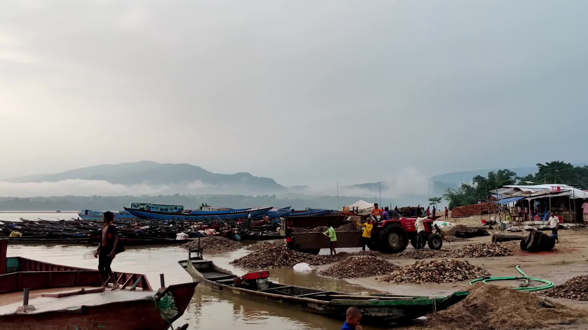 Workers carry and collect stones