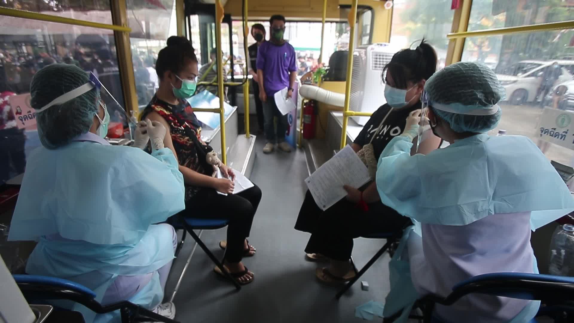 People get a dose of AstraZeneca vaccine on a BKK Mobile Vaccination Unit (BMV) vehicle in Bangkok