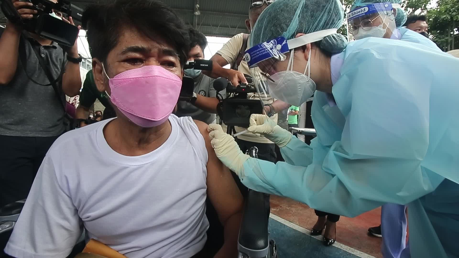People get a dose of AstraZeneca vaccine on a BKK Mobile Vaccination Unit (BMV) vehicle in Bangkok