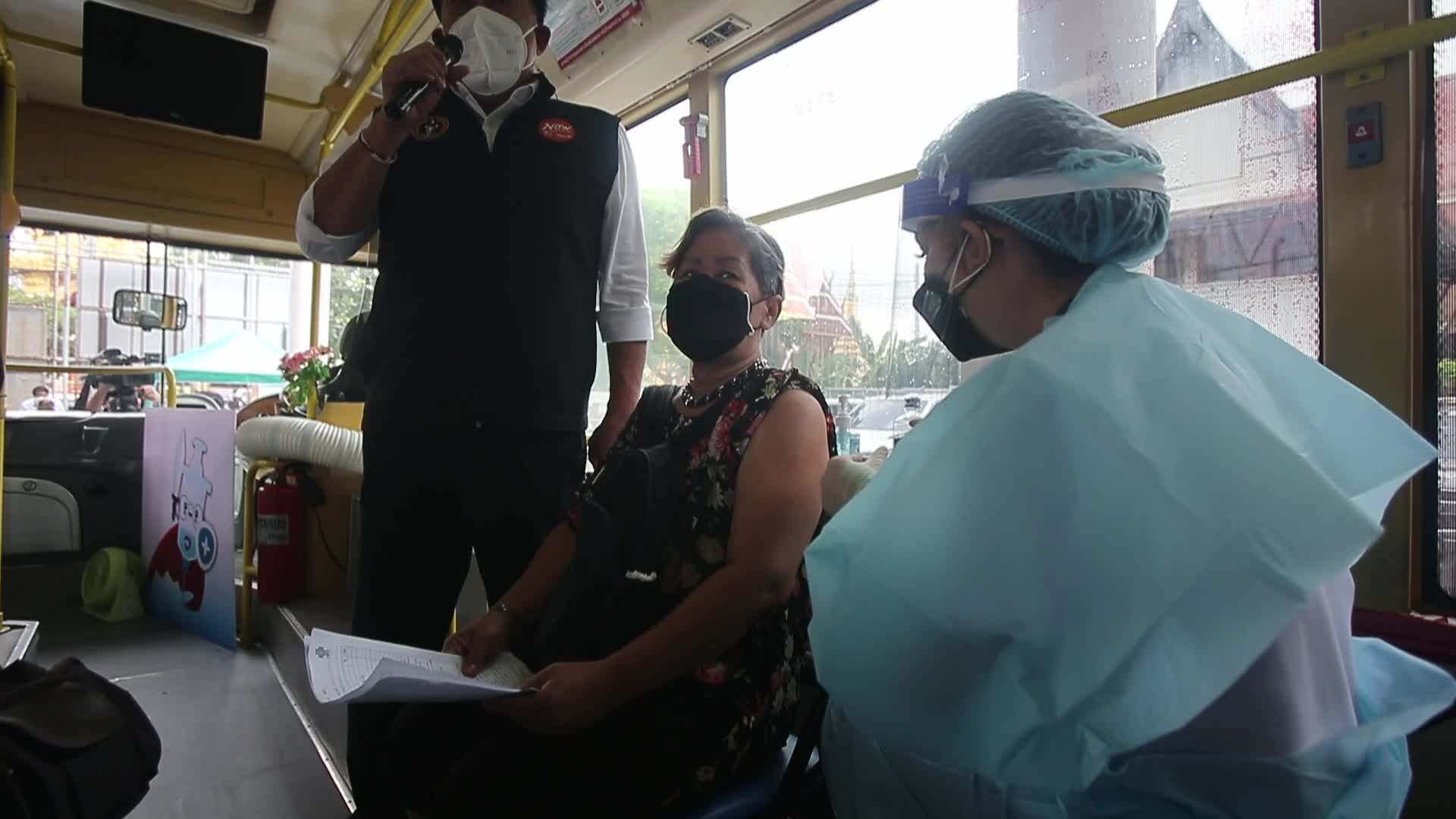 People get a dose of AstraZeneca vaccine on a BKK Mobile Vaccination Unit (BMV) vehicle in Bangkok