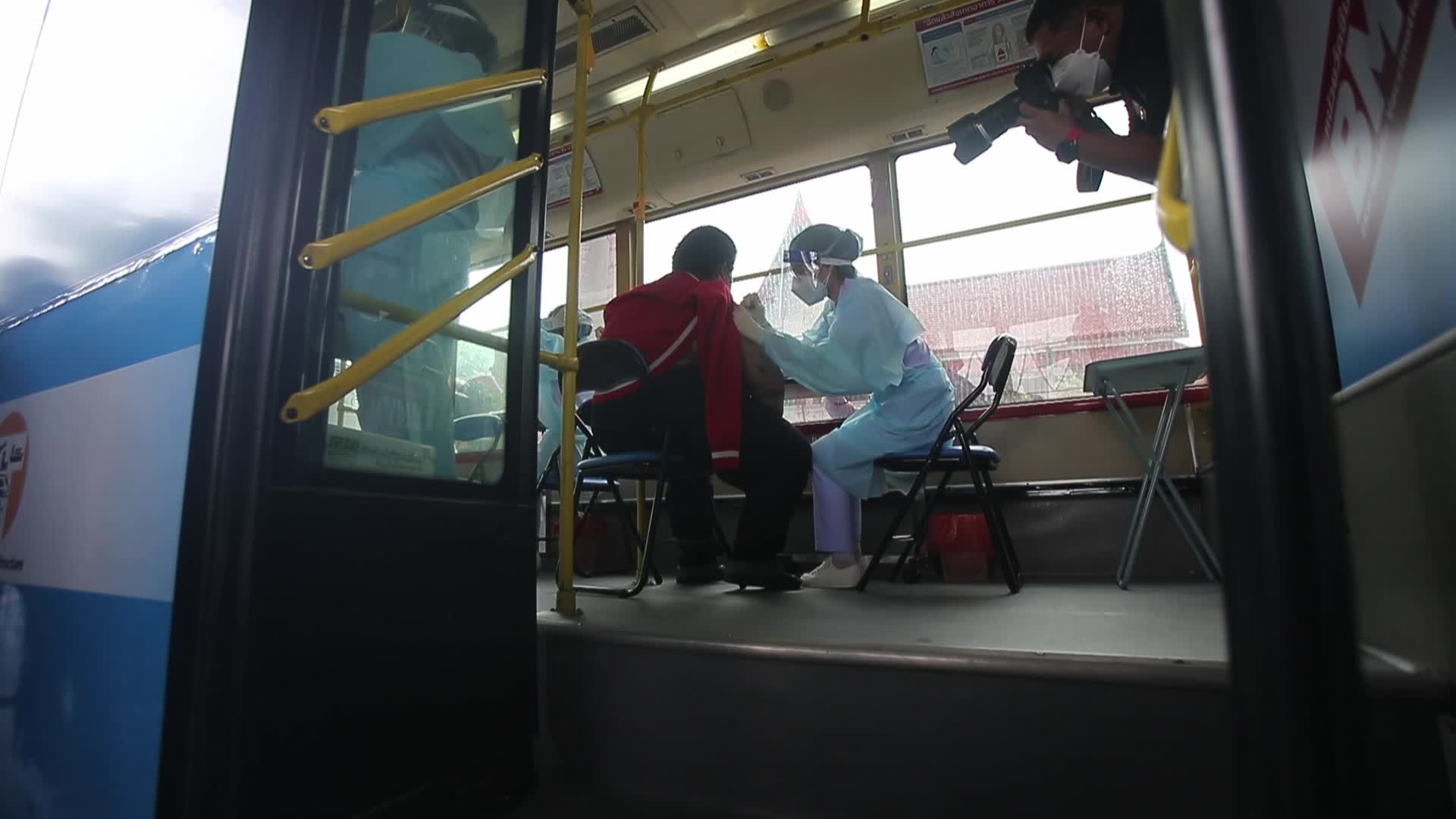 People get a dose of AstraZeneca vaccine on a BKK Mobile Vaccination Unit (BMV) vehicle in Bangkok