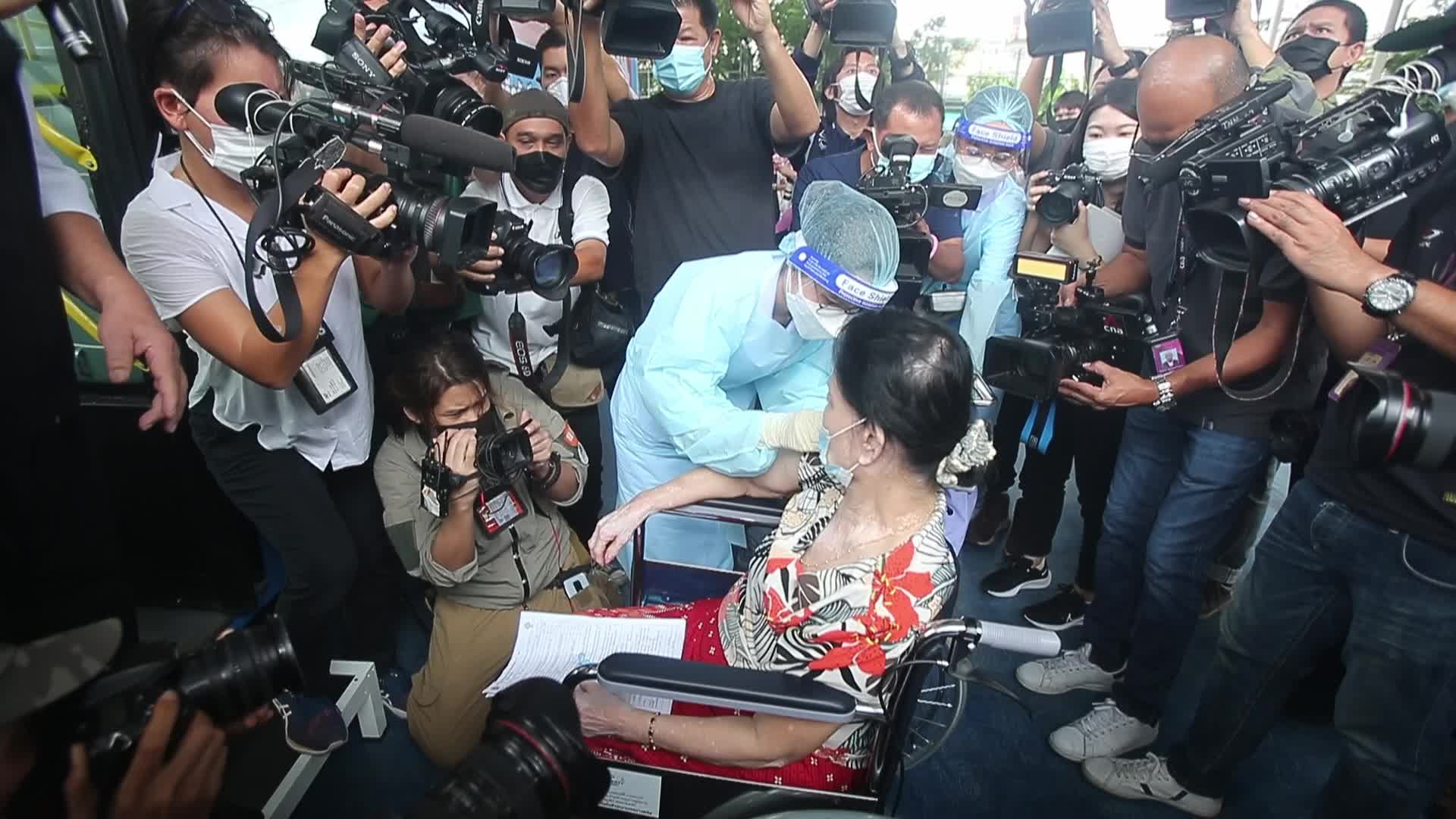 People get a dose of AstraZeneca vaccine on a BKK Mobile Vaccination Unit (BMV) vehicle in Bangkok