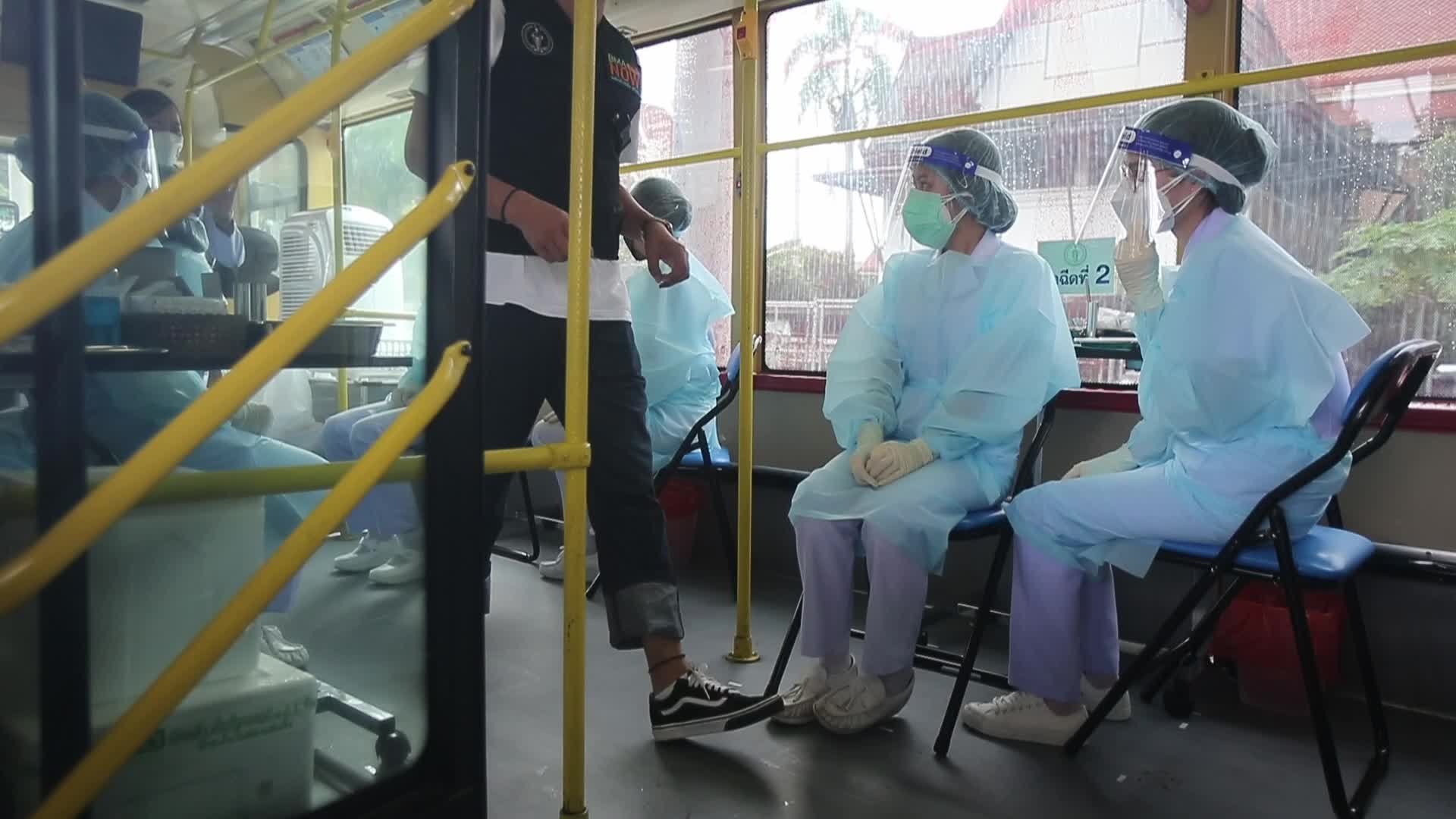 People get a dose of AstraZeneca vaccine on a BKK Mobile Vaccination Unit (BMV) vehicle in Bangkok