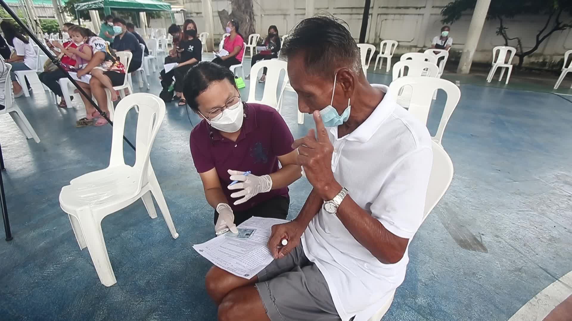 People get a dose of AstraZeneca vaccine on a BKK Mobile Vaccination Unit (BMV) vehicle in Bangkok