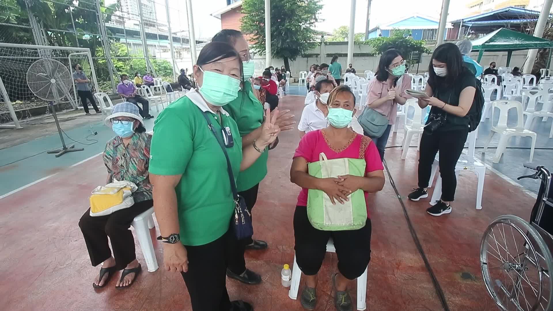 People get a dose of AstraZeneca vaccine on a BKK Mobile Vaccination Unit (BMV) vehicle in Bangkok