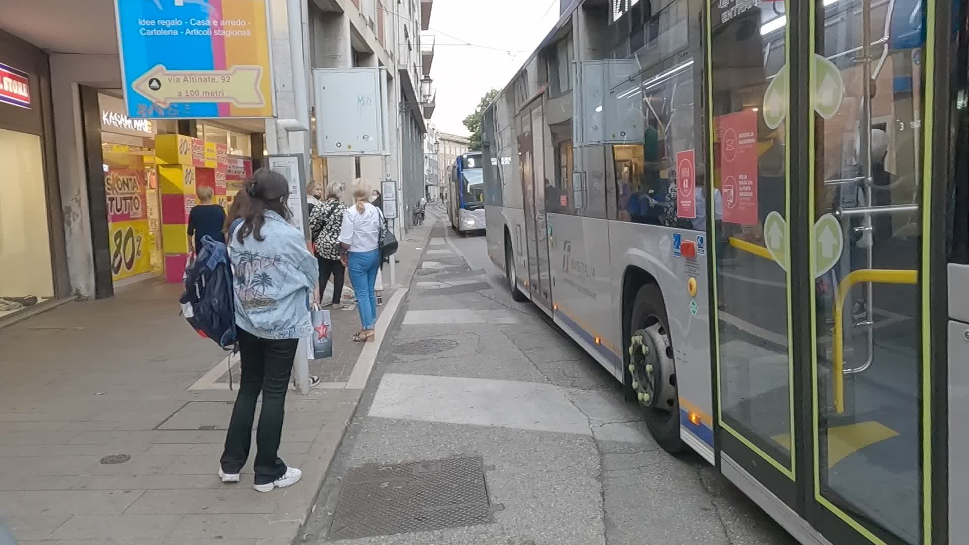 A girl waits for the bus in Padua in Via Roma.