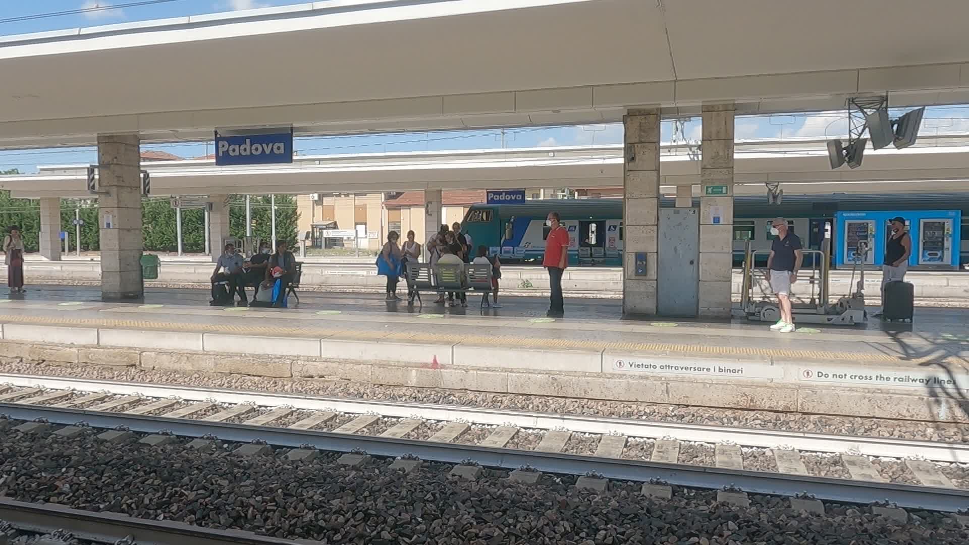 Workers waiting to catch a train at the Padua station