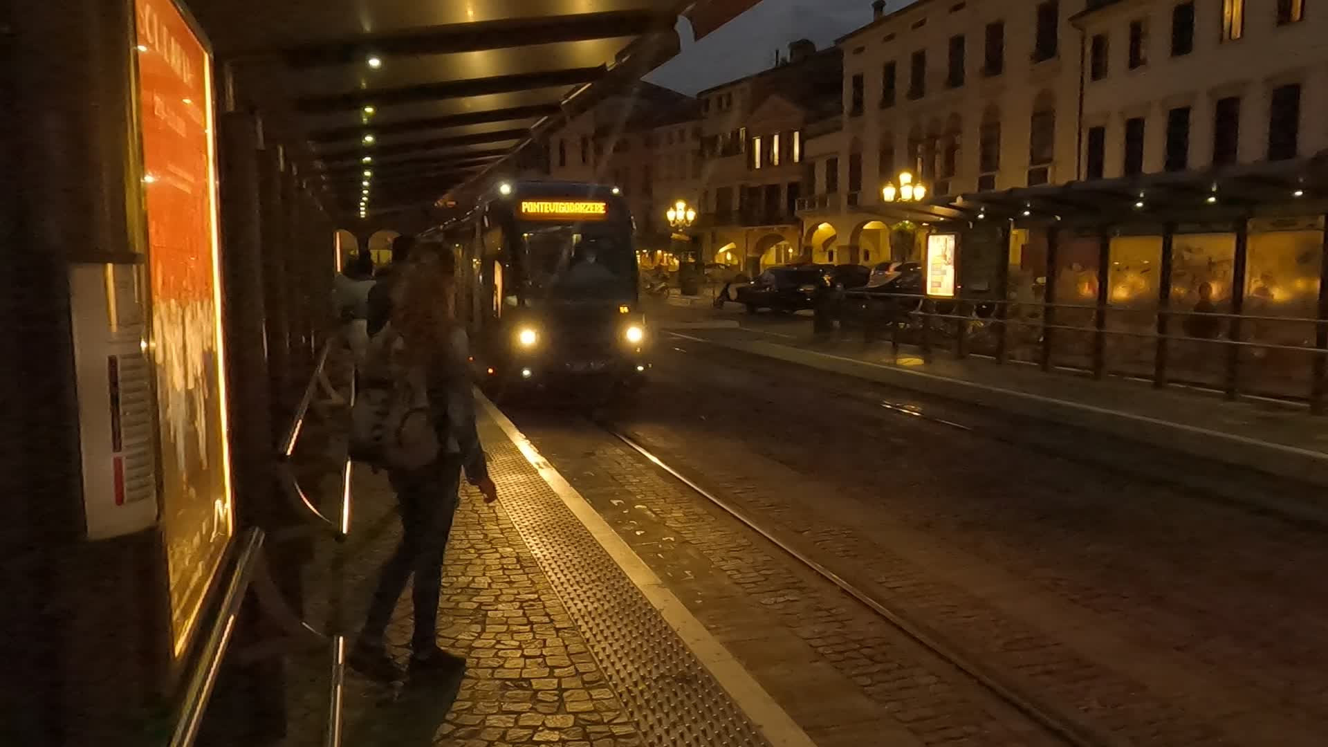 Tourists wait for the night tram in Prato della Valle in Padua