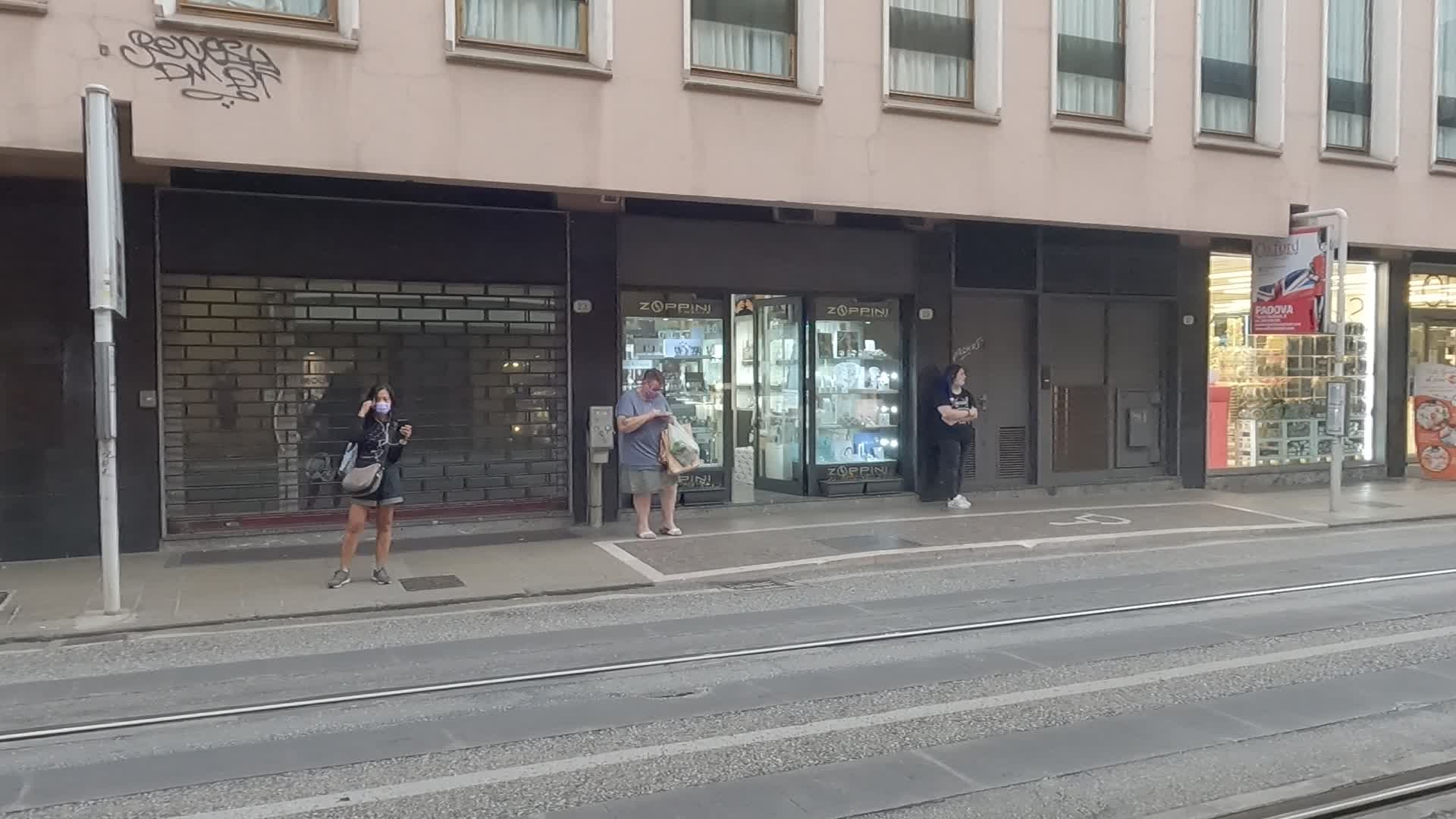 Passengers waiting at a bus platform in Padua 