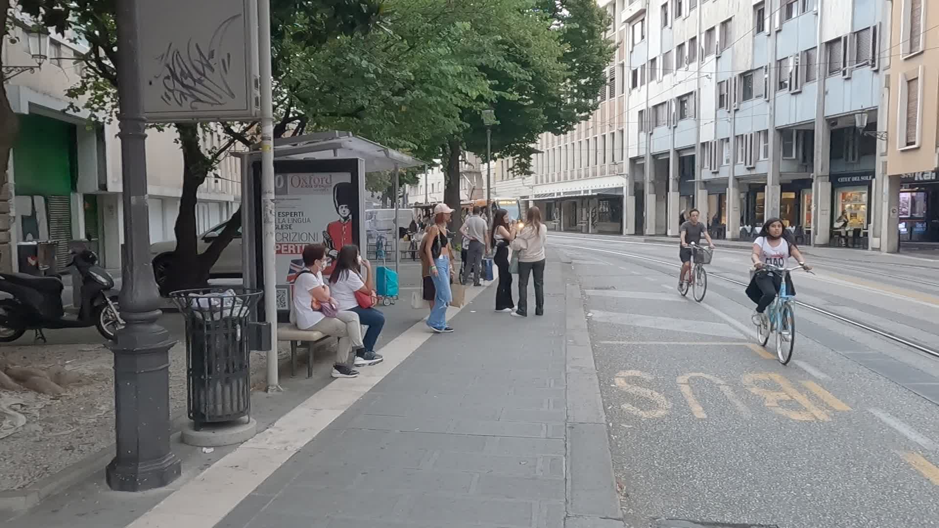 Passengers waiting for public transport in via Roma in Padua