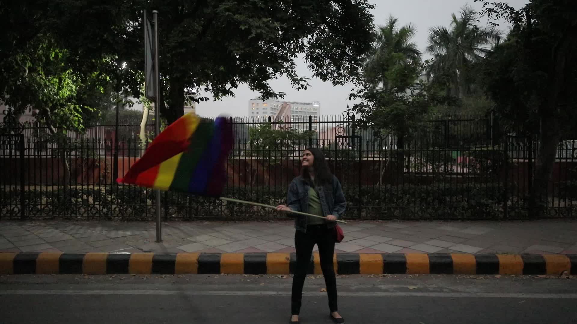Girl waving Rainbow/LGBT pride flag in Pride Parade in Delhi, India