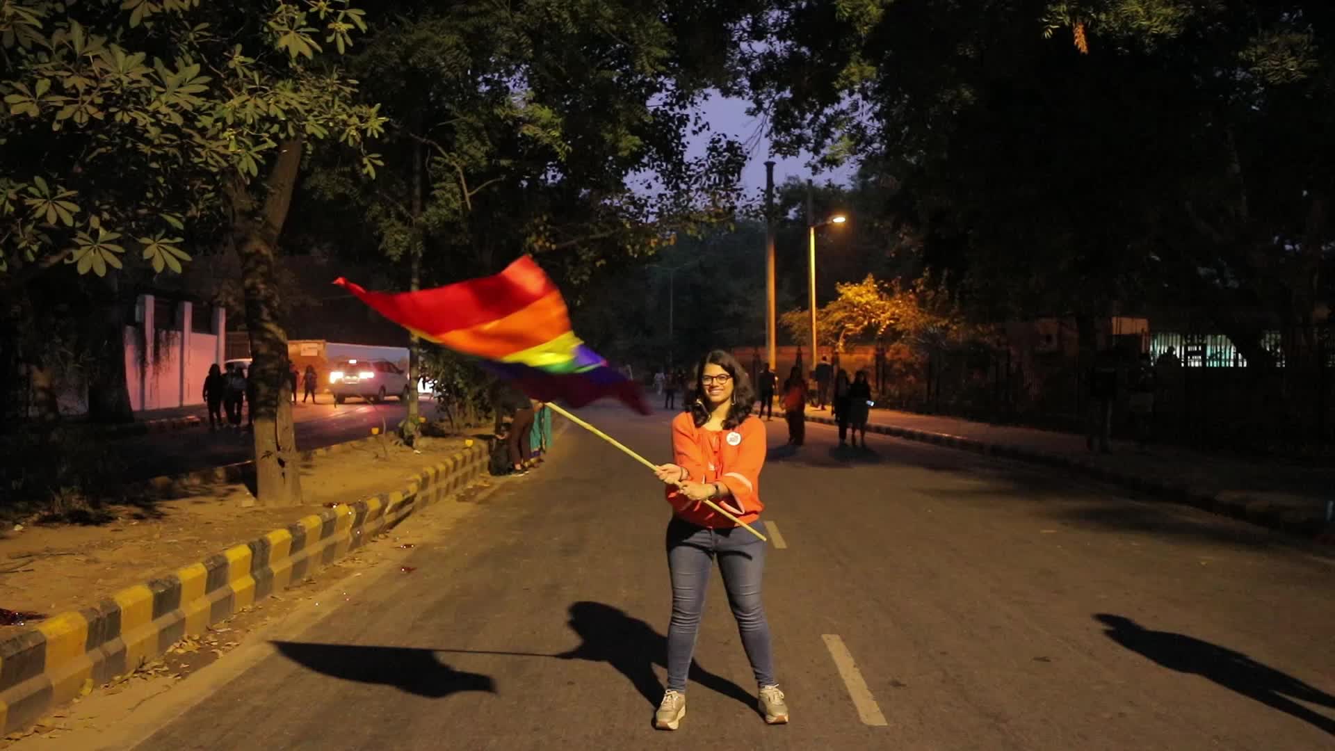 Girl waves LGBT pride flag in Pride Parade in Delhi, India