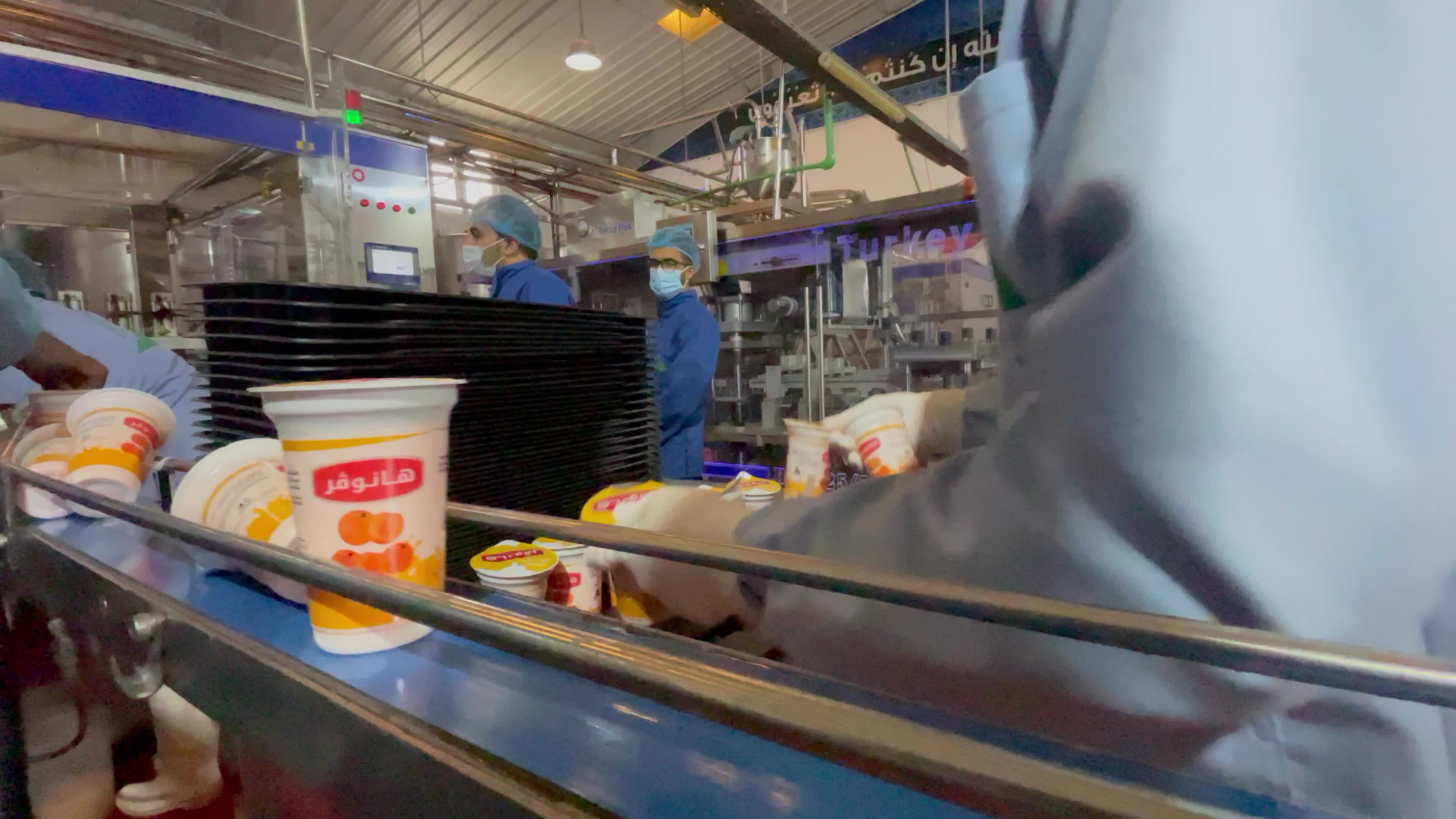 Palestinian employees work at Hanover factory for dairy