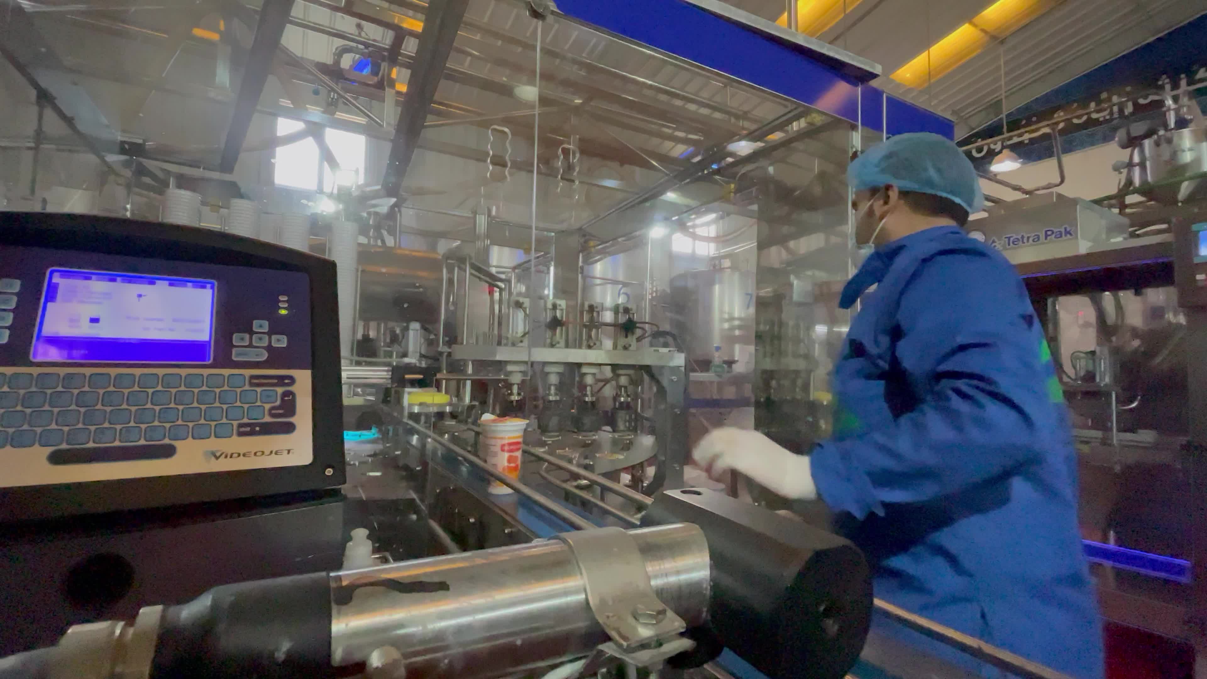 Palestinian employees work at Hanover factory for dairy
