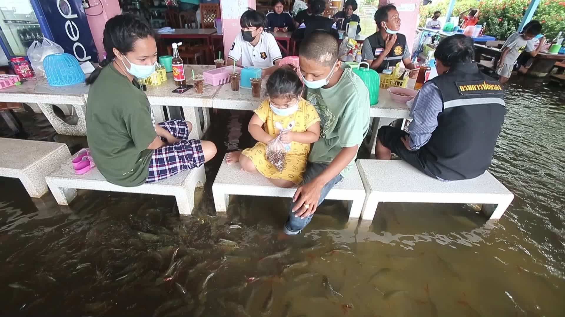 Water overflows from the Tha Chin river in a flooded-noodle shop