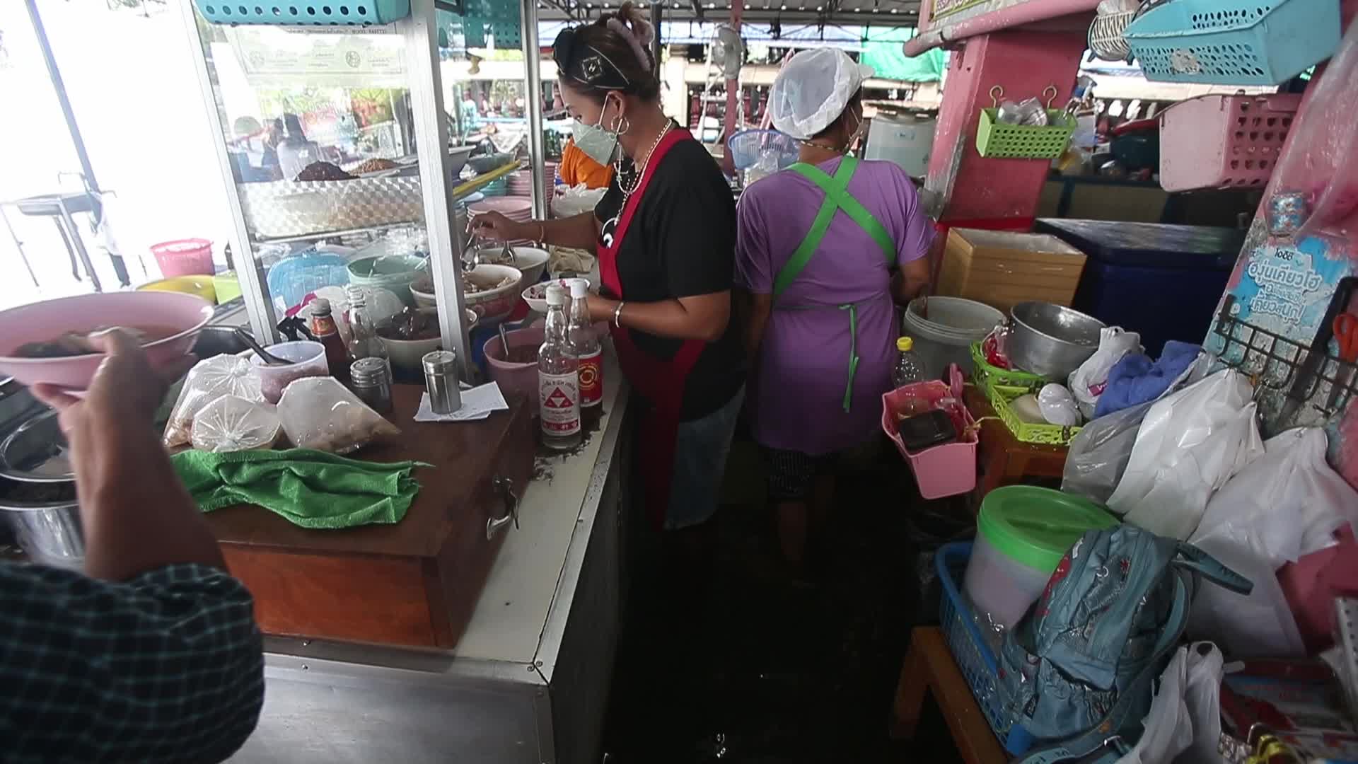 Water overflows from the Tha Chin river in a flooded-noodle shop
