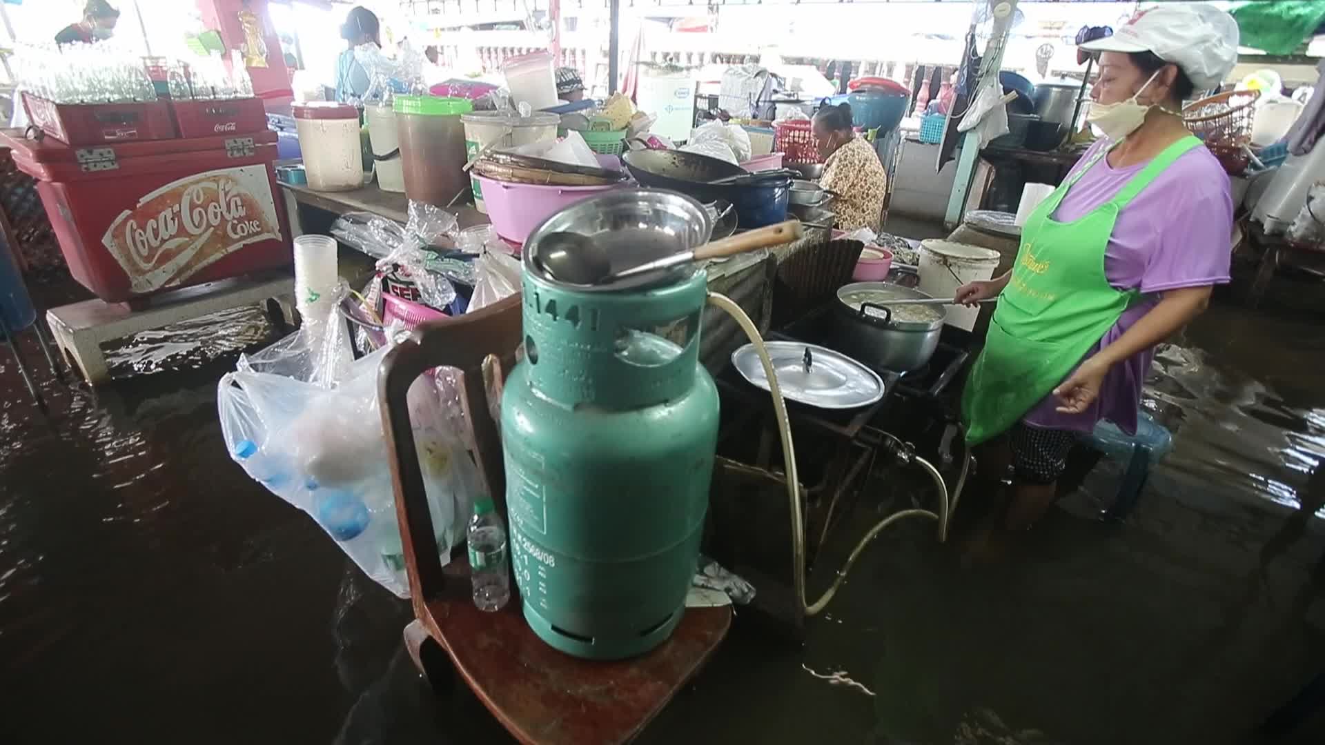 Water overflows from the Tha Chin river in a flooded-noodle shop