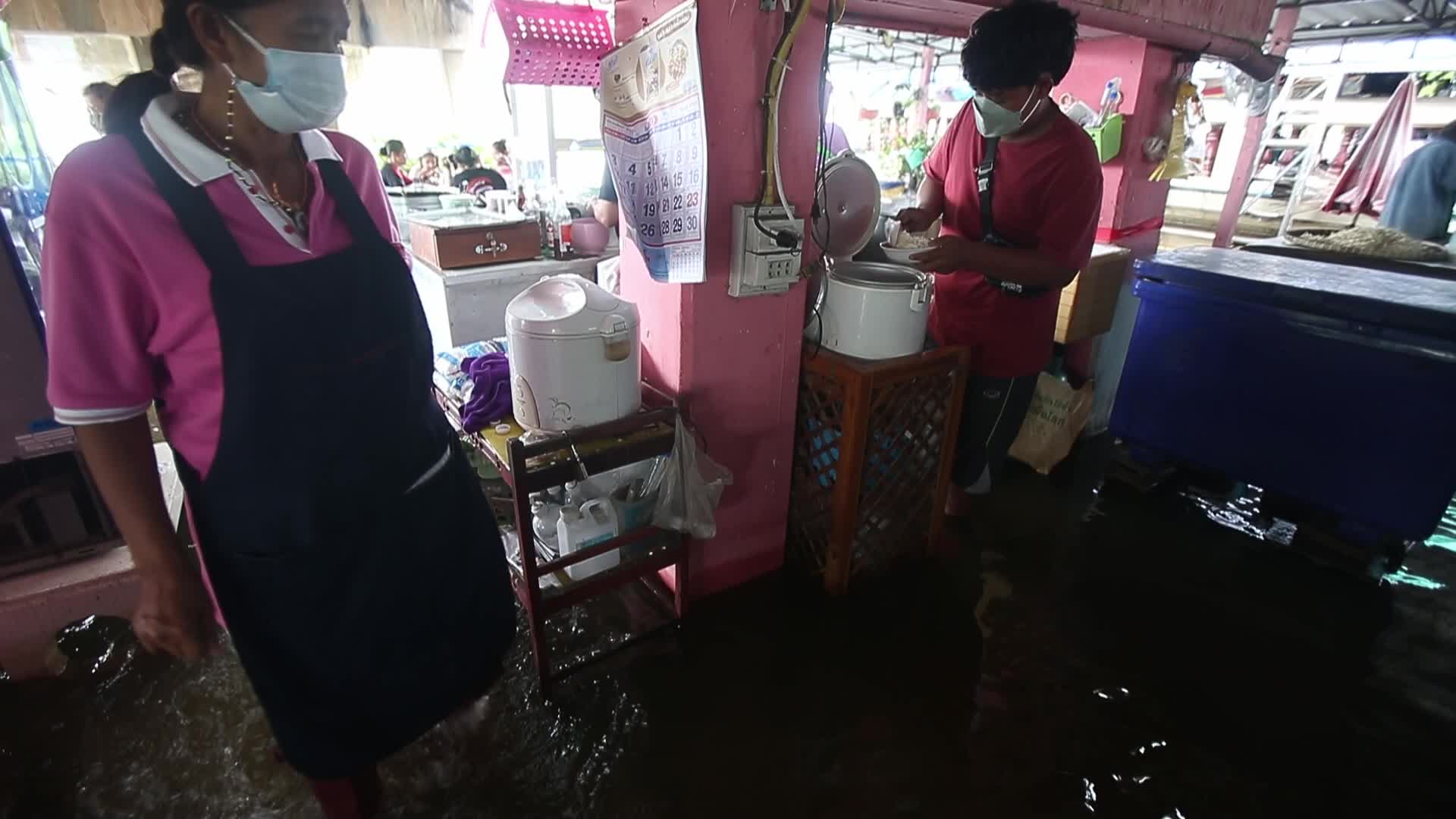 Water overflows from the Tha Chin river in a flooded-noodle shop