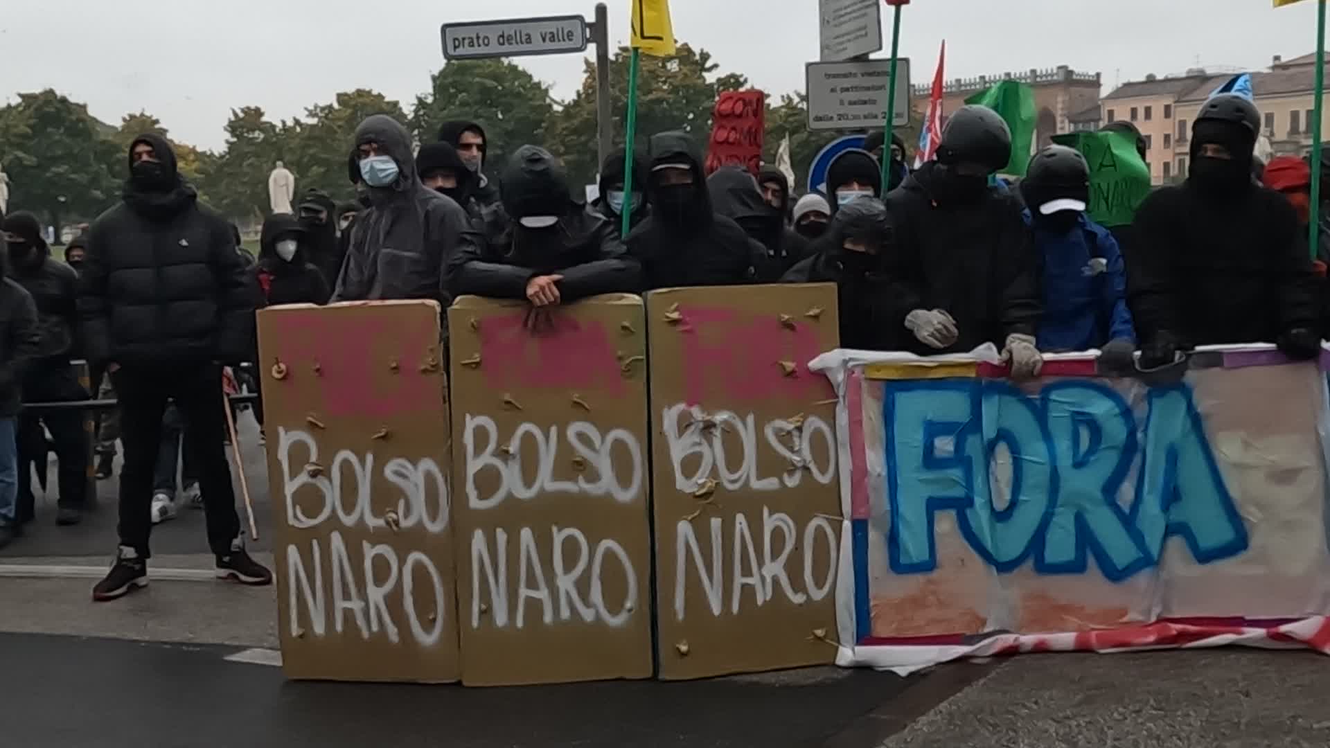 Protesters parade with a banner against Jair Bolsonaro