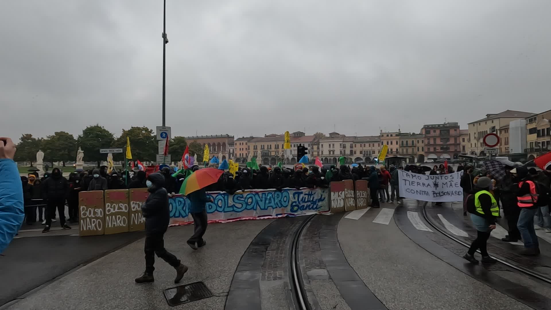 Protesters parade with a banner against Jair Bolsonaro
