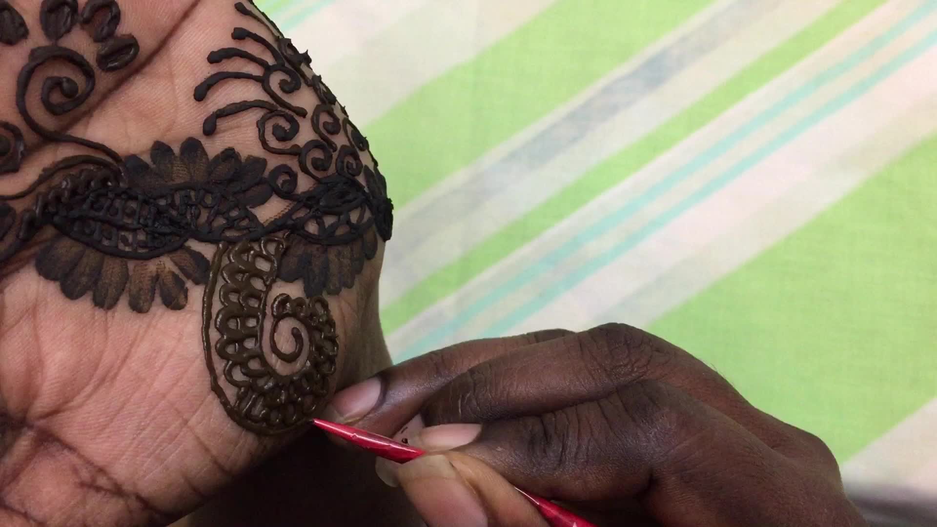 Henna is applied to the hands of a Hindu woman during Diwali