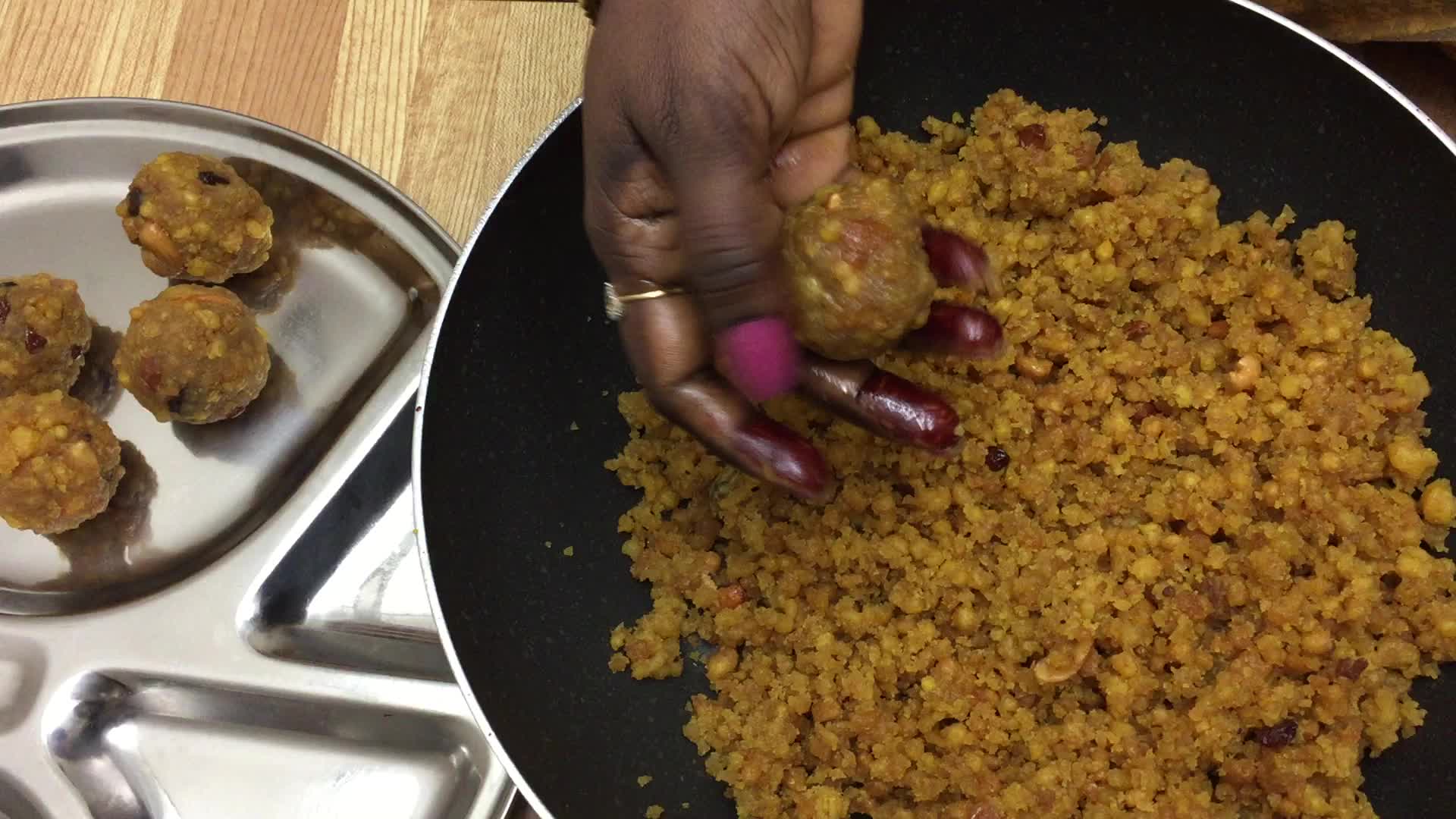 Woman prepares laddus during the Hindu festival of Diwali 