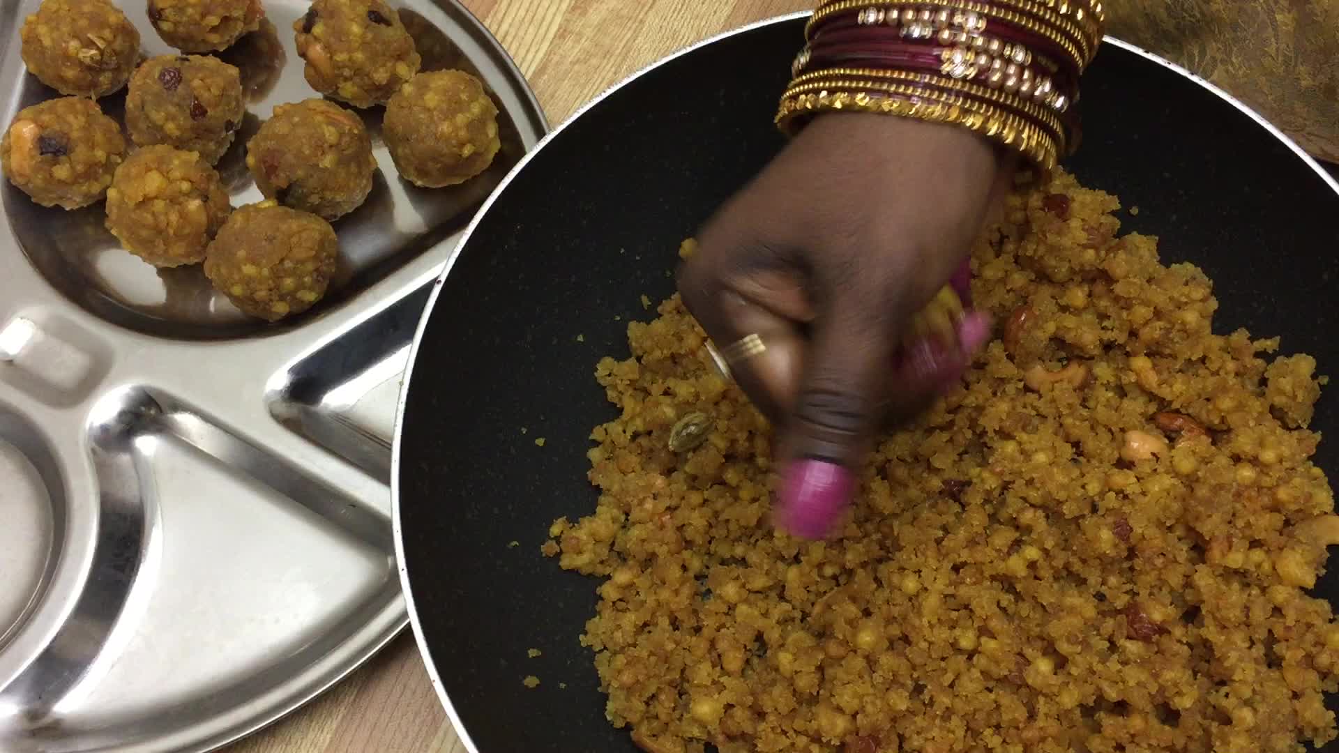 Woman prepares laddus during the Hindu festival of Diwali 