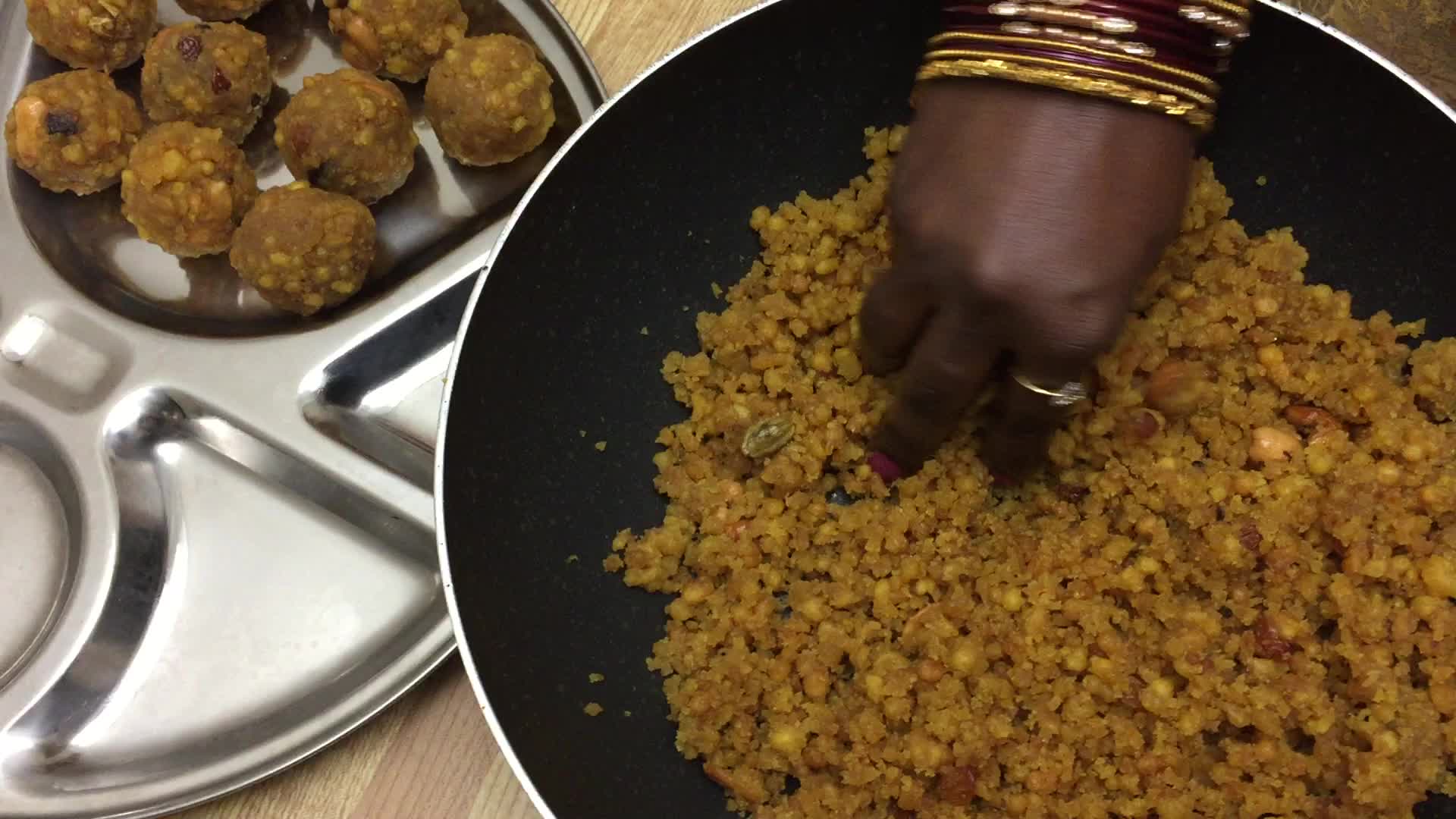 Woman prepares laddus during the Hindu festival of Diwali 