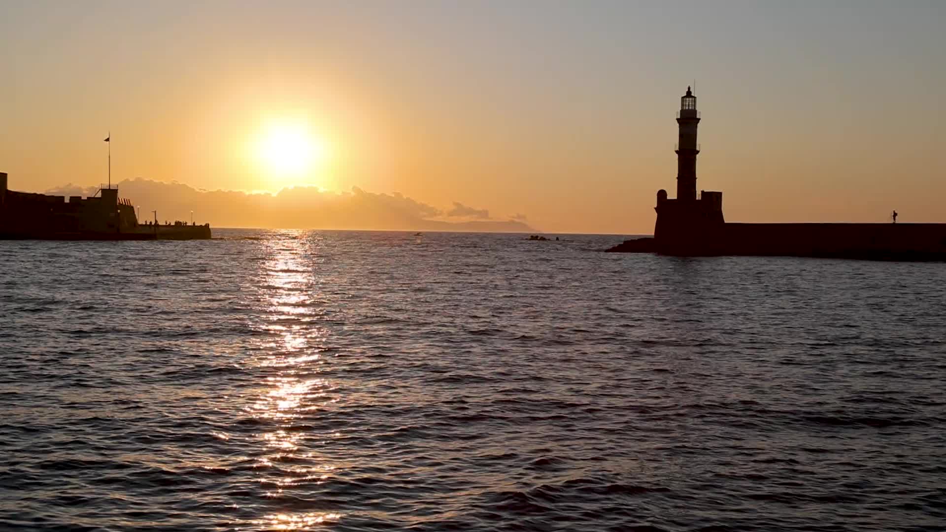Magical sunset behind the lighthouse in Chania, Crete island, Greece