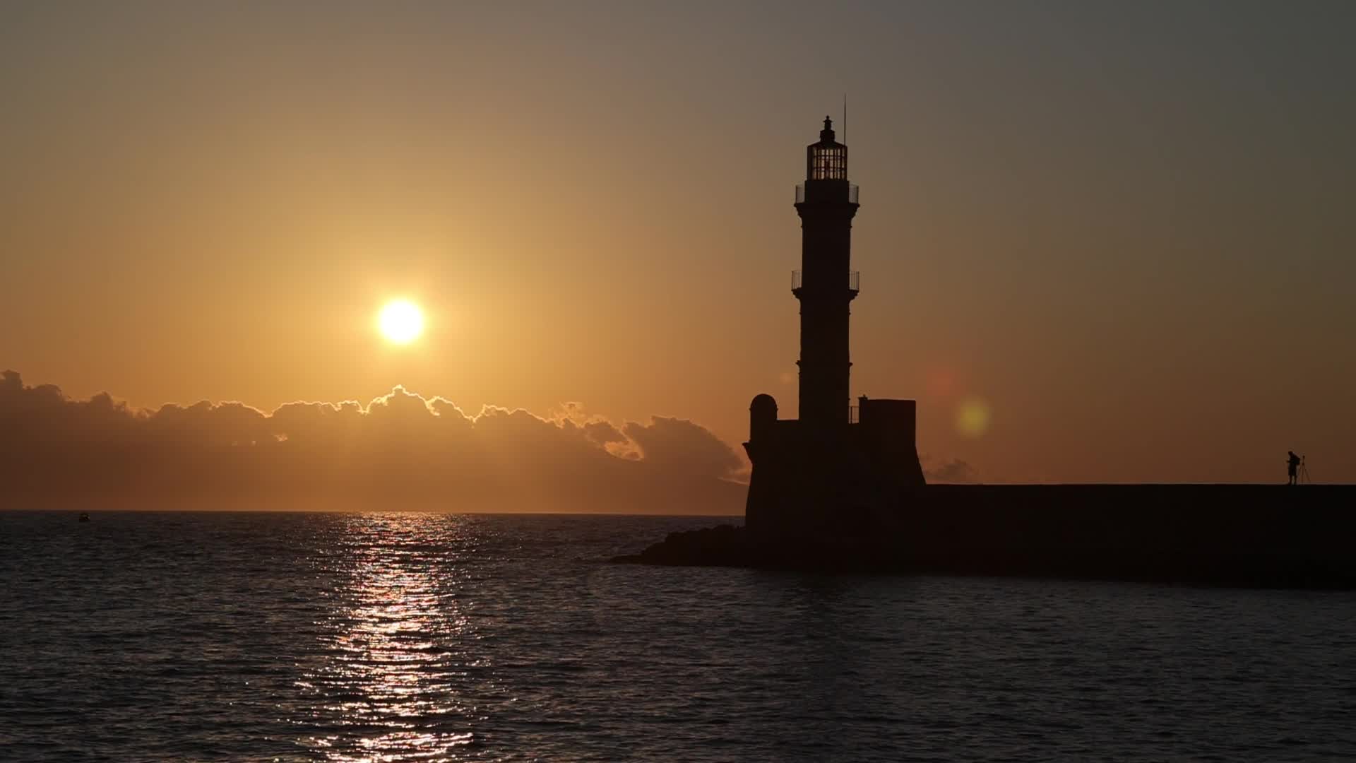 Magical sunset behind the lighthouse in Chania, Crete island, Greece