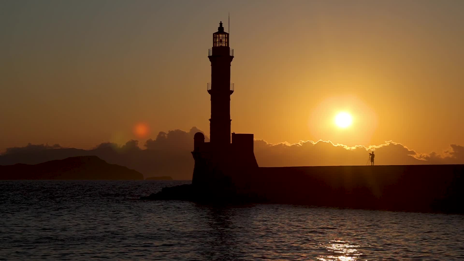 Magical sunset behind the lighthouse in Chania, Crete island, Greece